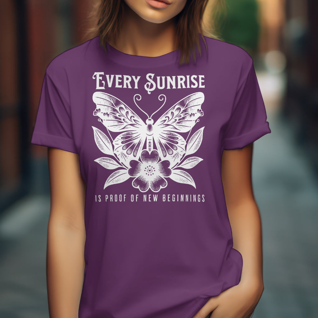 Every Sunrise Is Proof Of New Beginnings digital design on a purple t-shirt