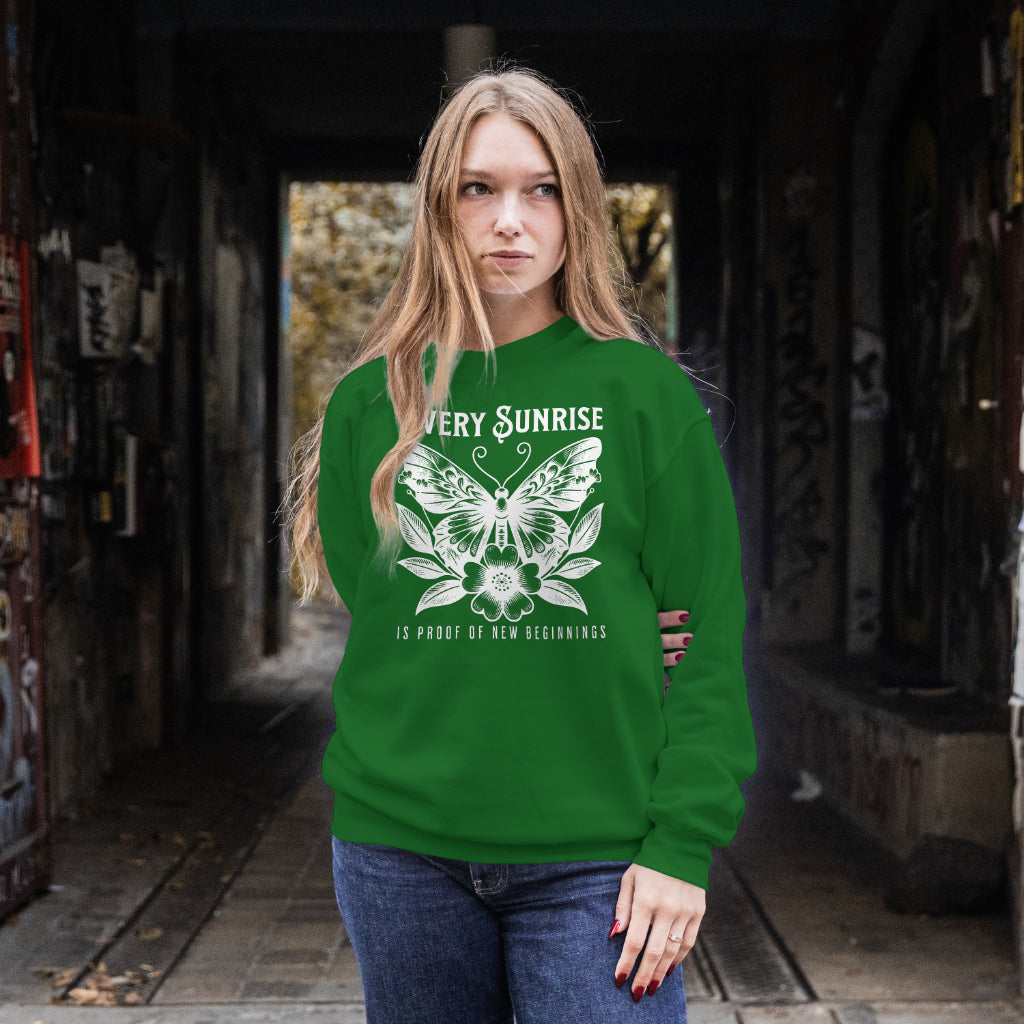 Every Sunrise Is Proof Of New Beginnings digital design on a green sweatshirt
