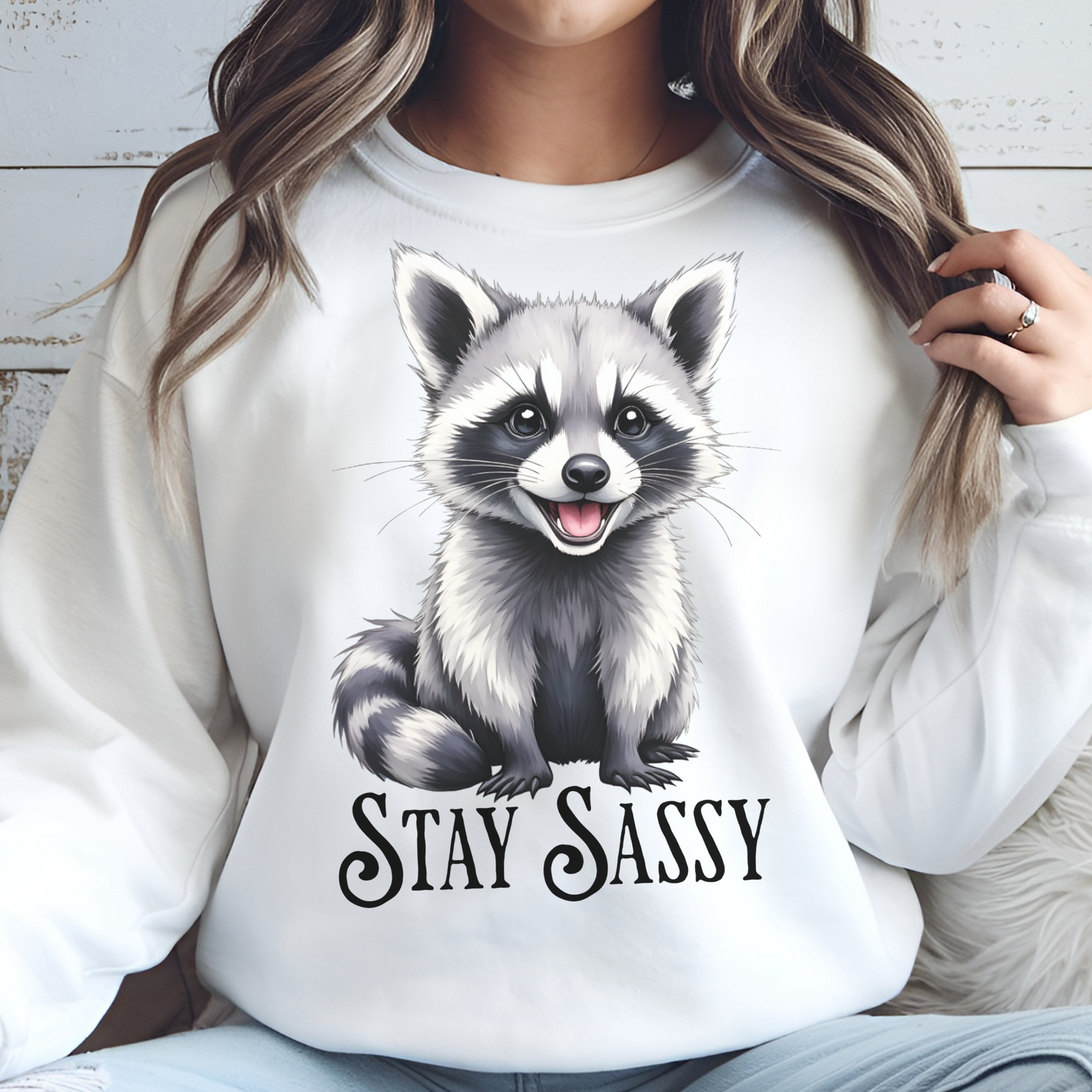 Stay Sassy raccoon png digital design on a woman's sweatshirt