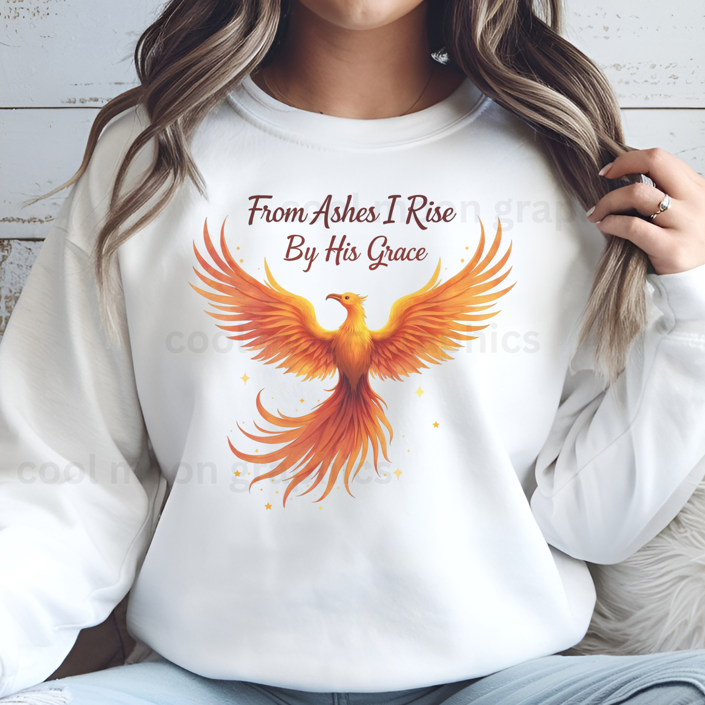 White sweatshirt with a phoenix design and text worn by a woman.