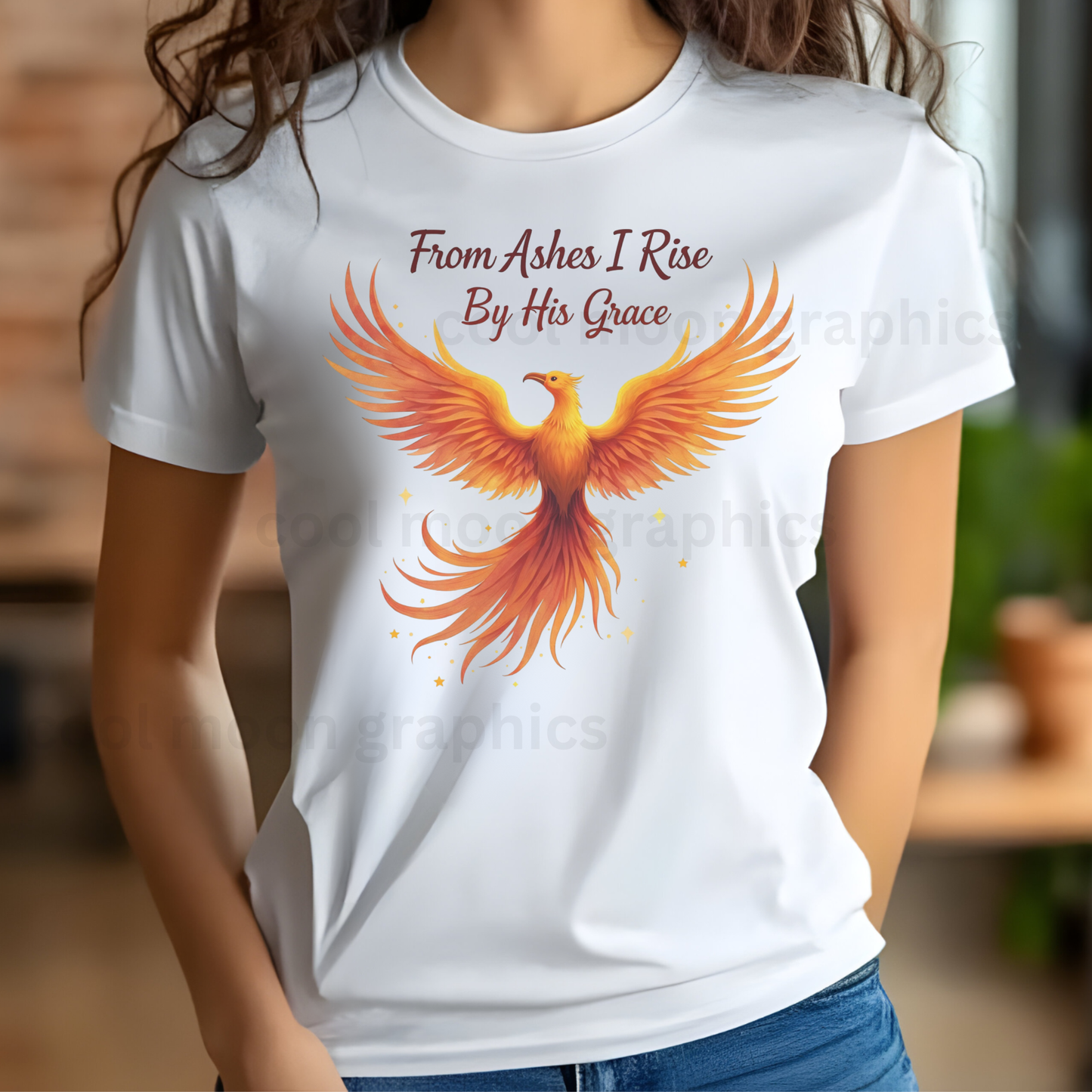 White t-shirt with a phoenix design and text worn by a woman indoors.