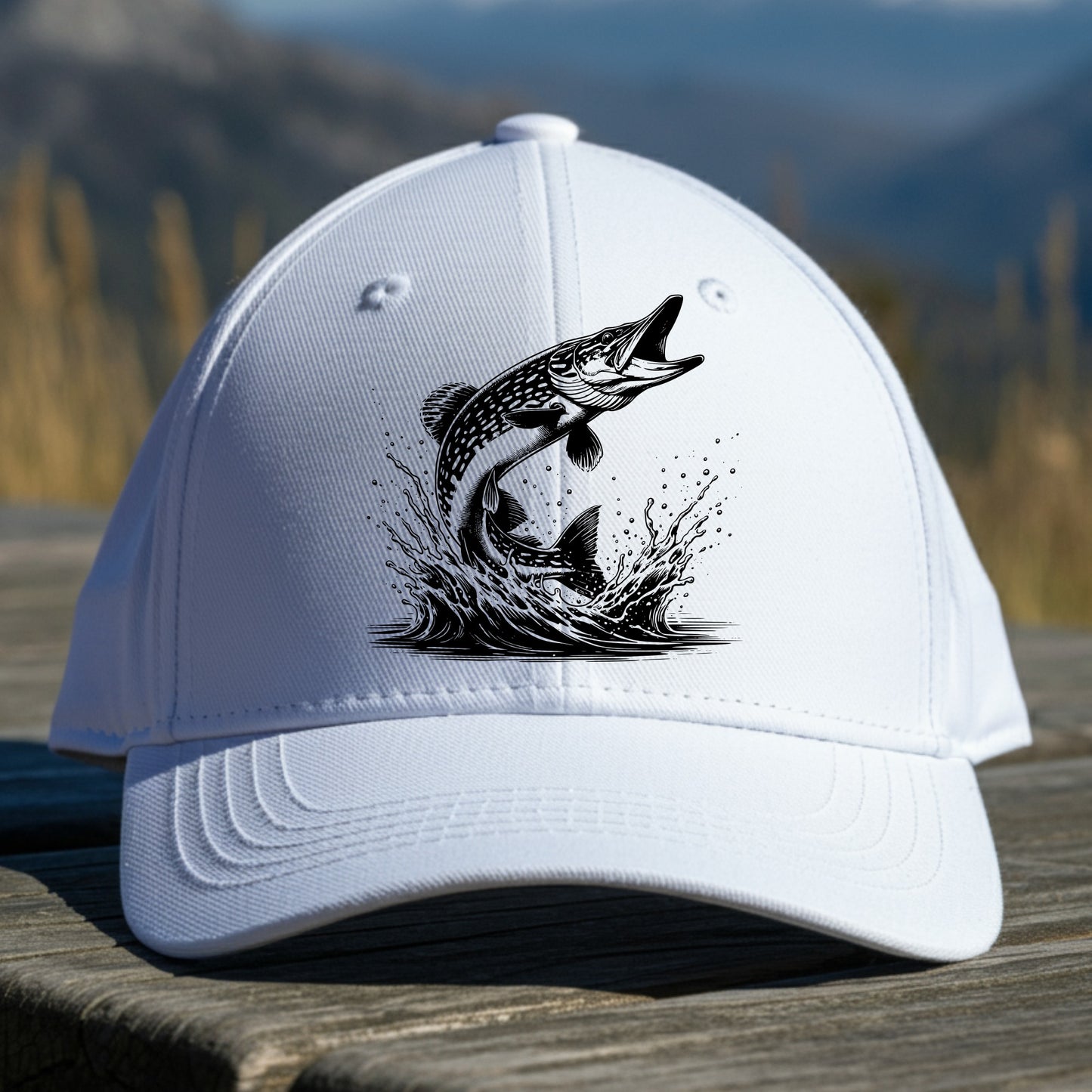 White cap with pike fish illustration on a wooden surface with a mountain background