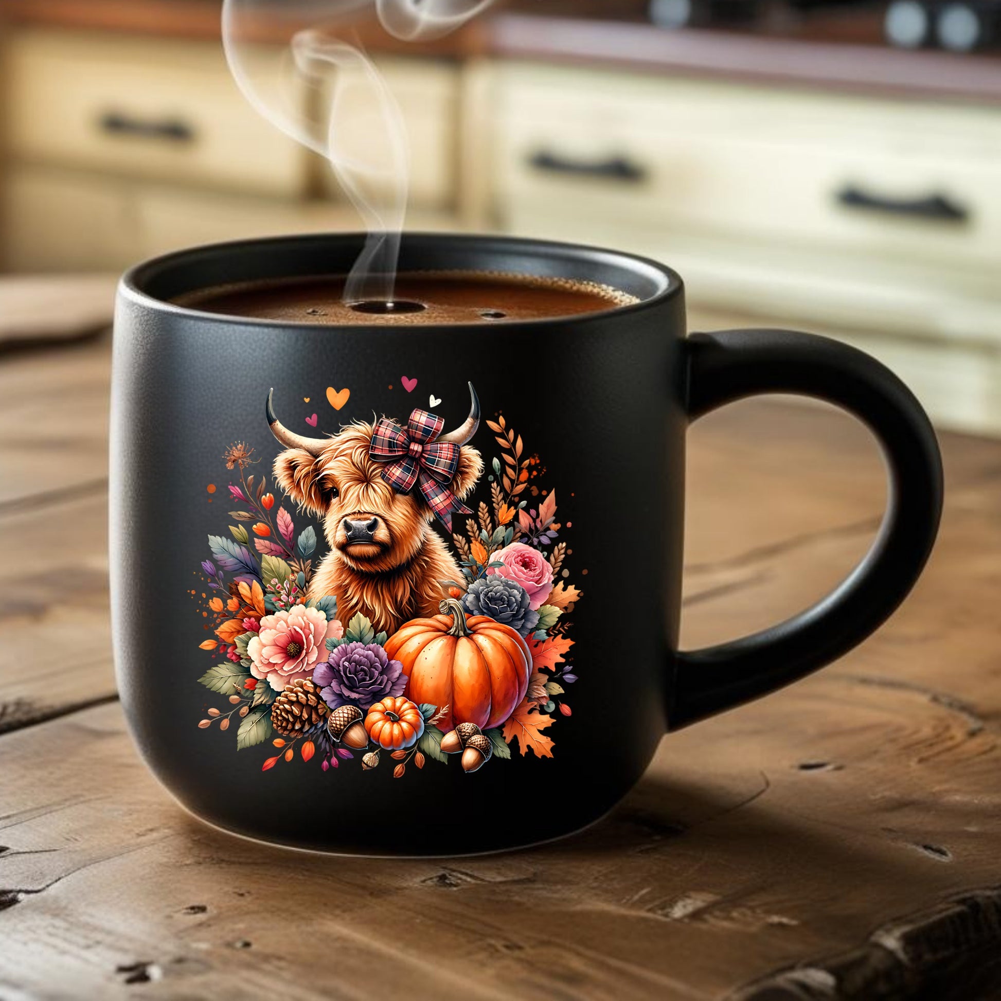 Black mug with a highland cow and pumpkin design on a wooden surface