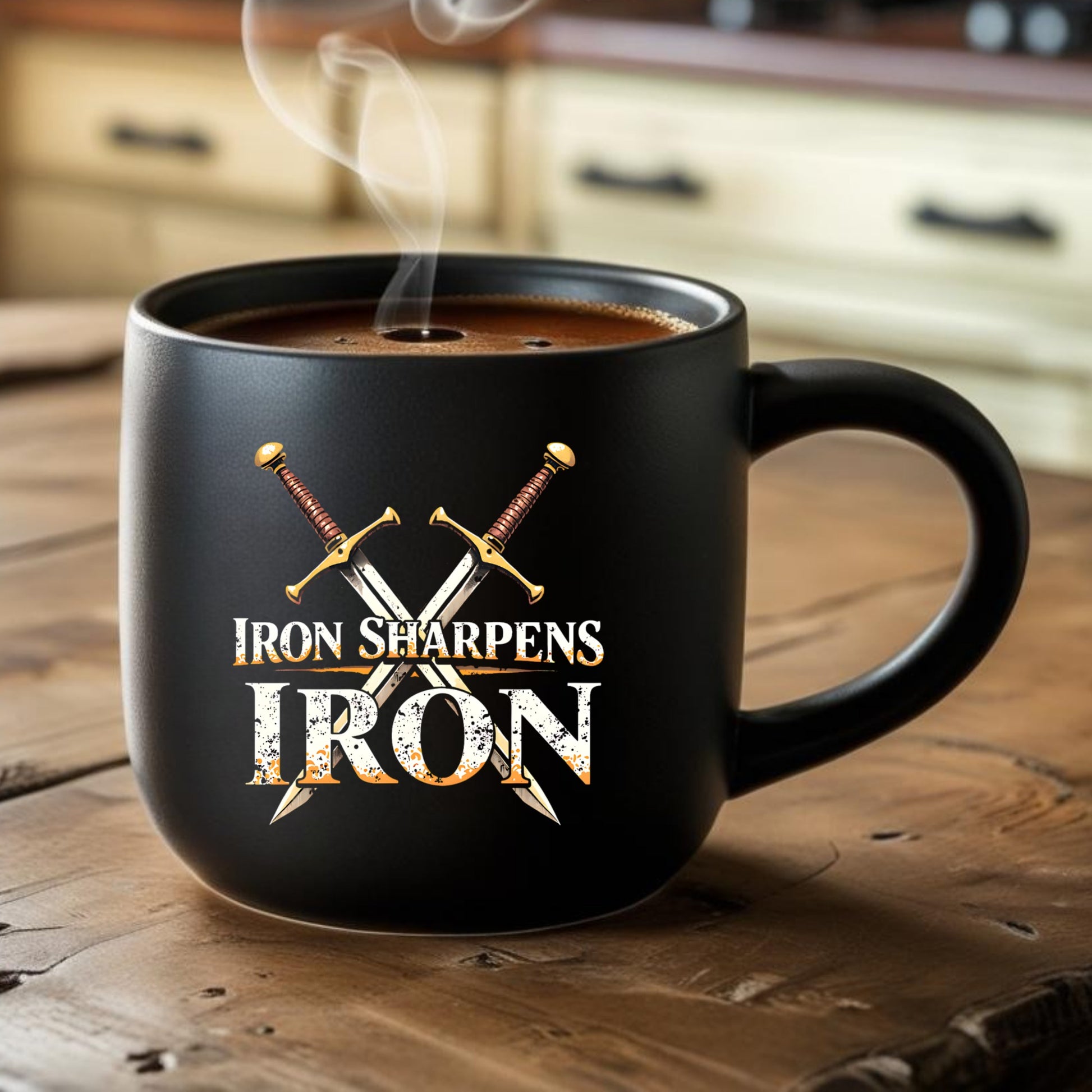 Black mug with 'Iron Sharpens Iron' text and crossed swords on a wooden surface with coffee.