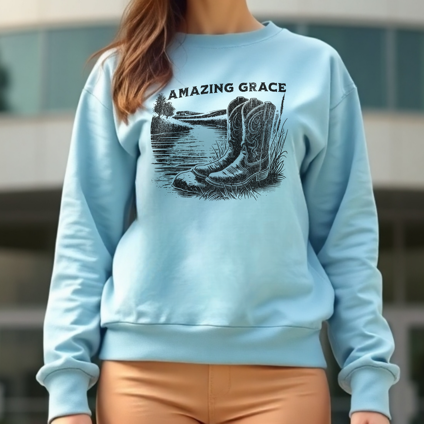 River Boots Amazing Grace digital design on a woman’s blue sweatshirt