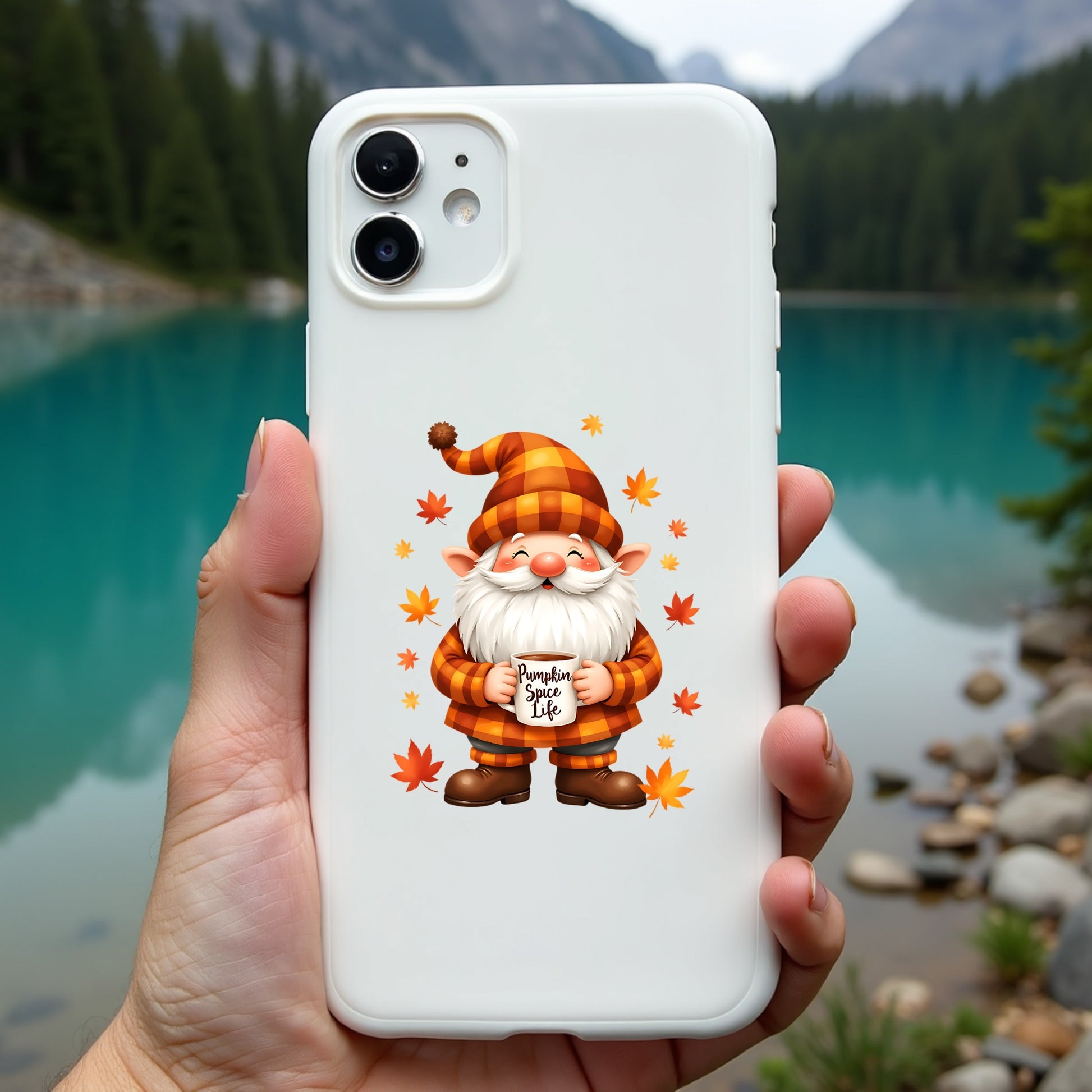 Phone case with a gnome design held in front of a scenic lake and mountains.