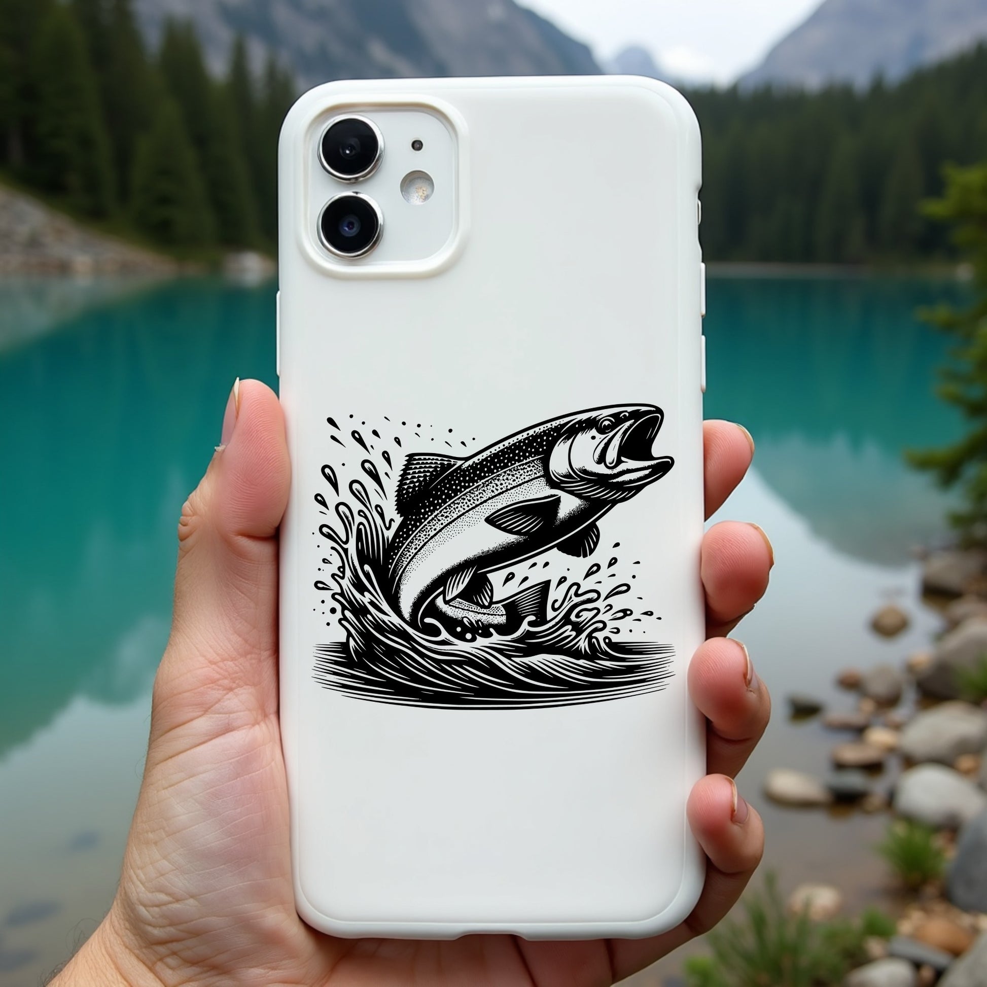 Phone case with a rainbow trout design held in front of a scenic lake and mountains.