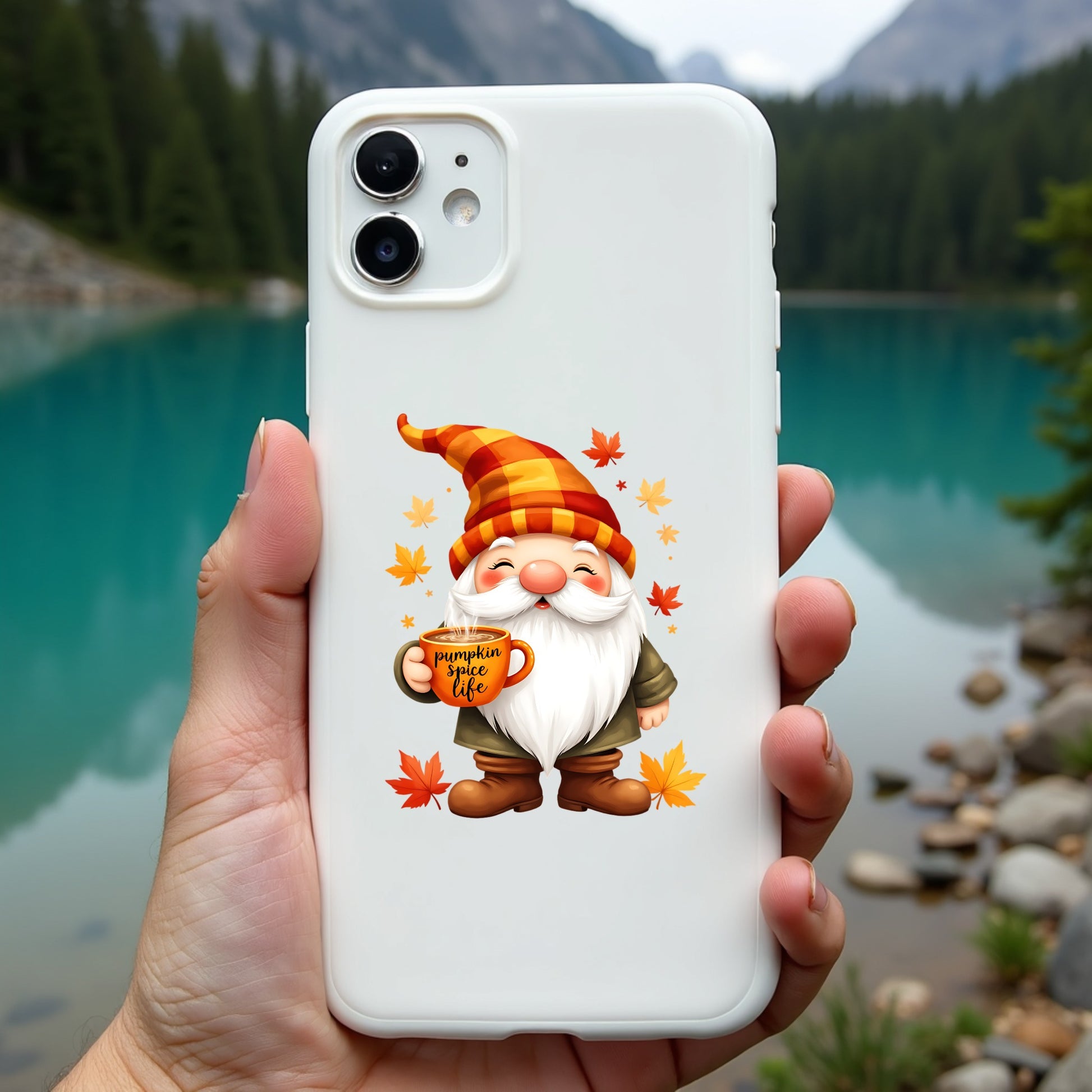Phone case with a gnome design held in front of a scenic lake.