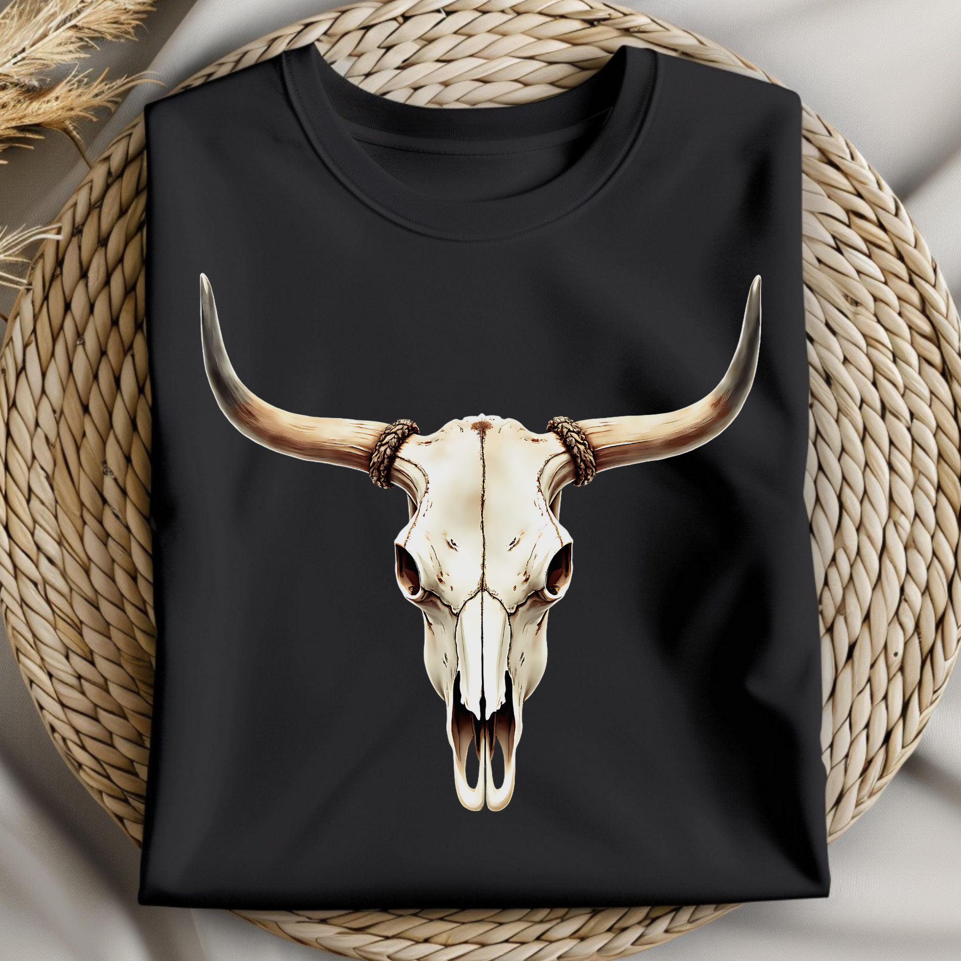 Bull Skull With Horns PNG digital design on a folded black t-shirt