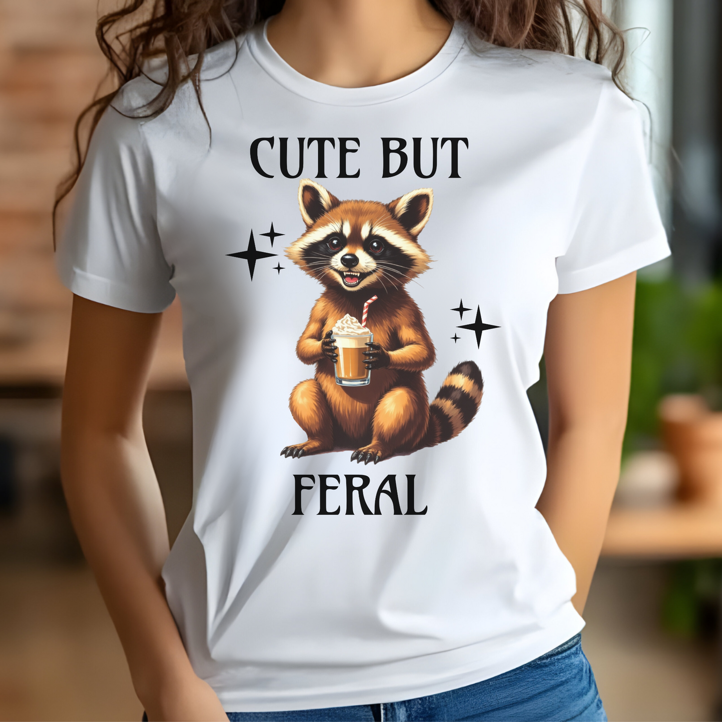 Cute But Feral raccoon holding a latte digital design on a woman's white t-shirt