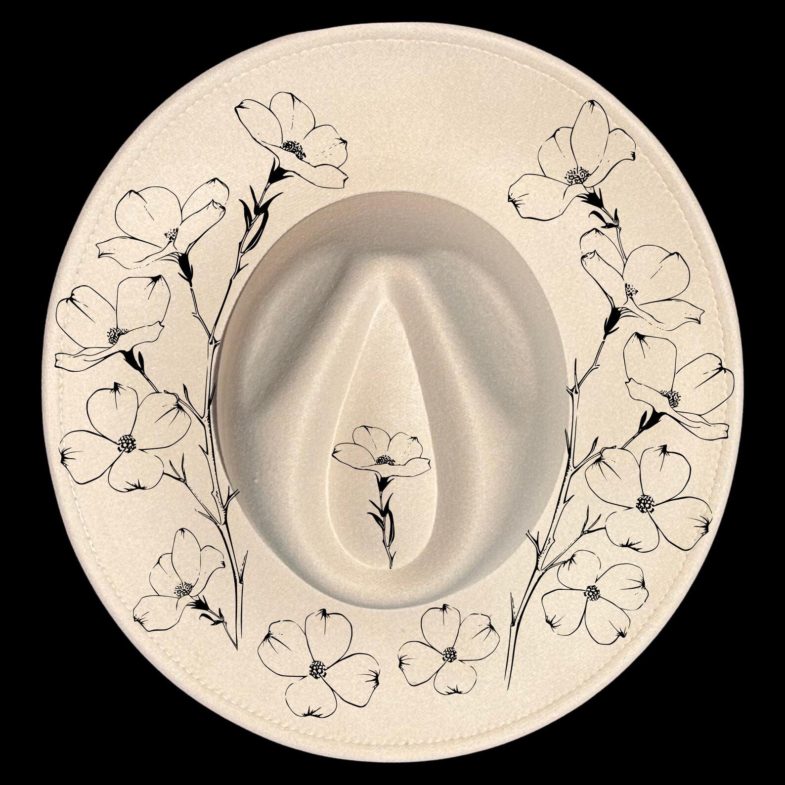 Wide brim hat with floral pattern on a black background