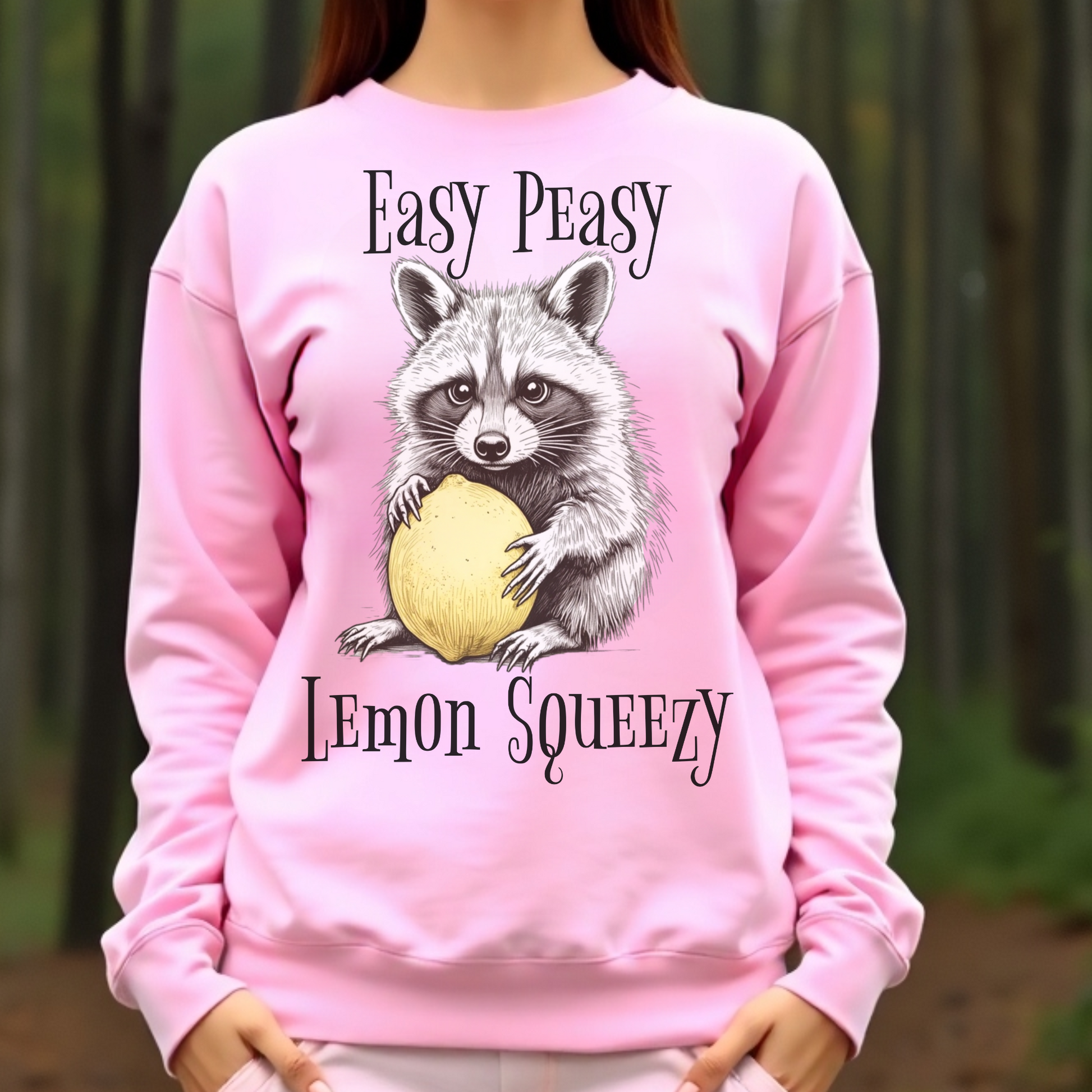 Easy Peasy Lemon Squeezy raccoon holding a lemon digital design on a pink sweatshirt
