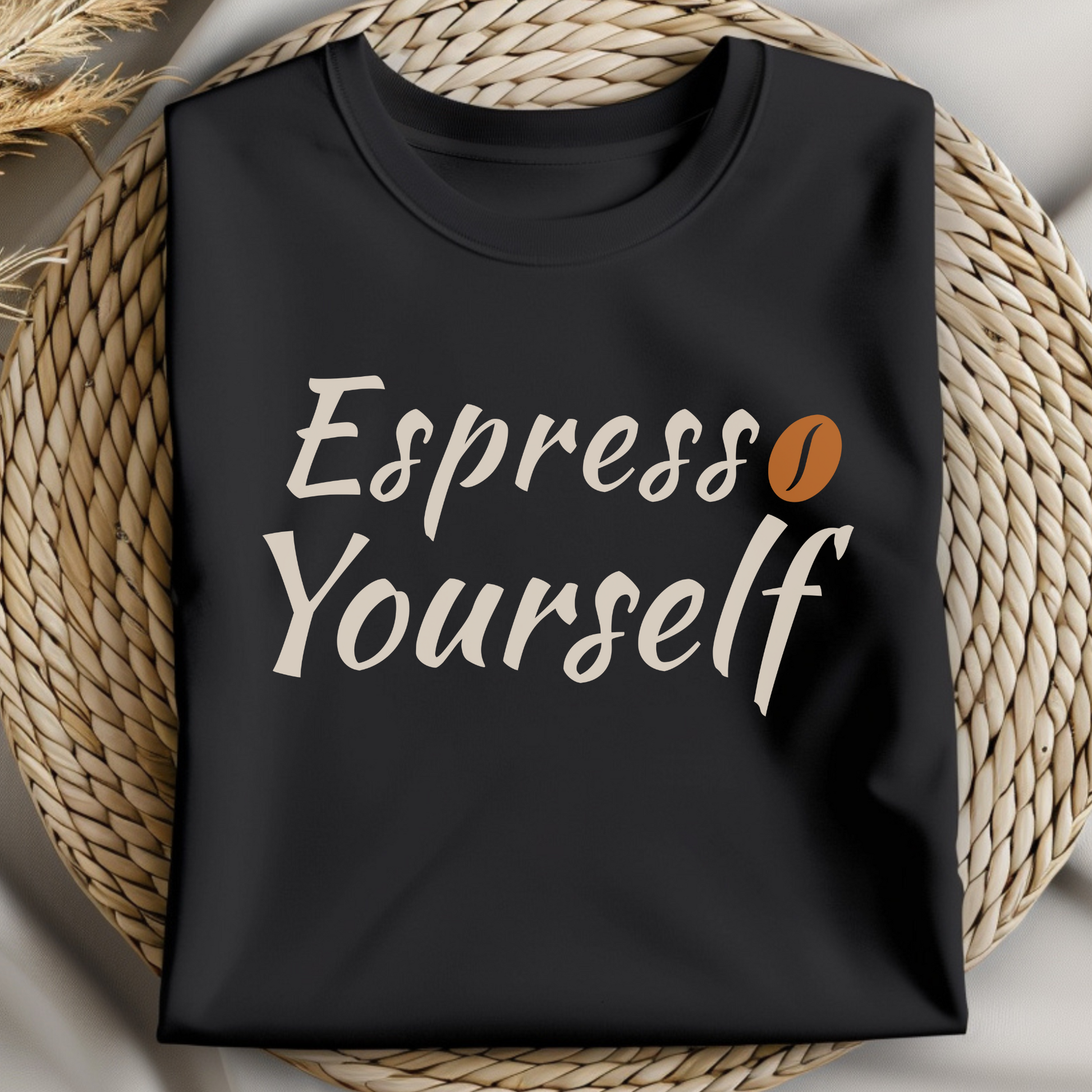 Espresso Yourself PNG digital design with a coffee bean on a folded black t-shirt.