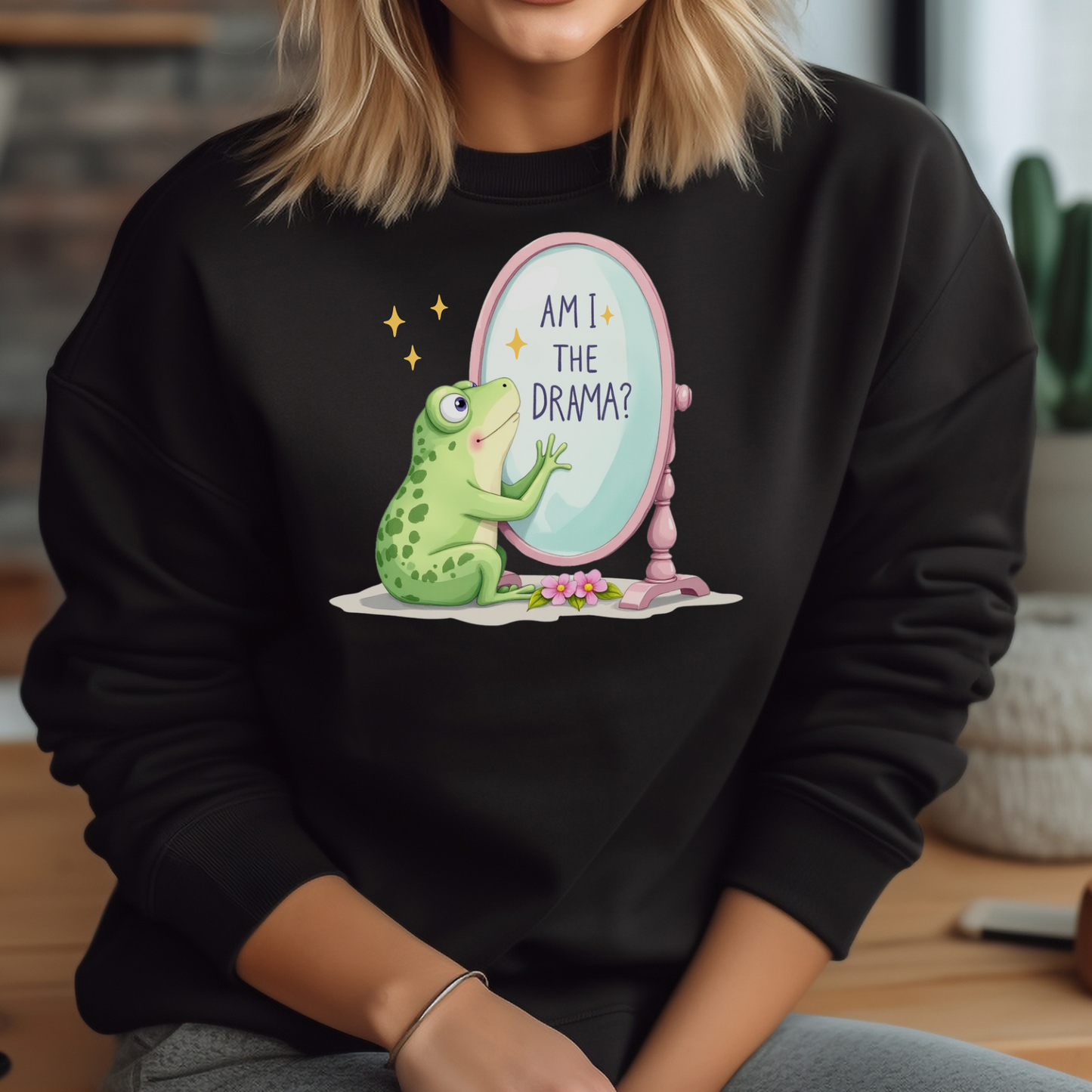 Am I The Drama? digital design on a woman’s black sweatshirt
