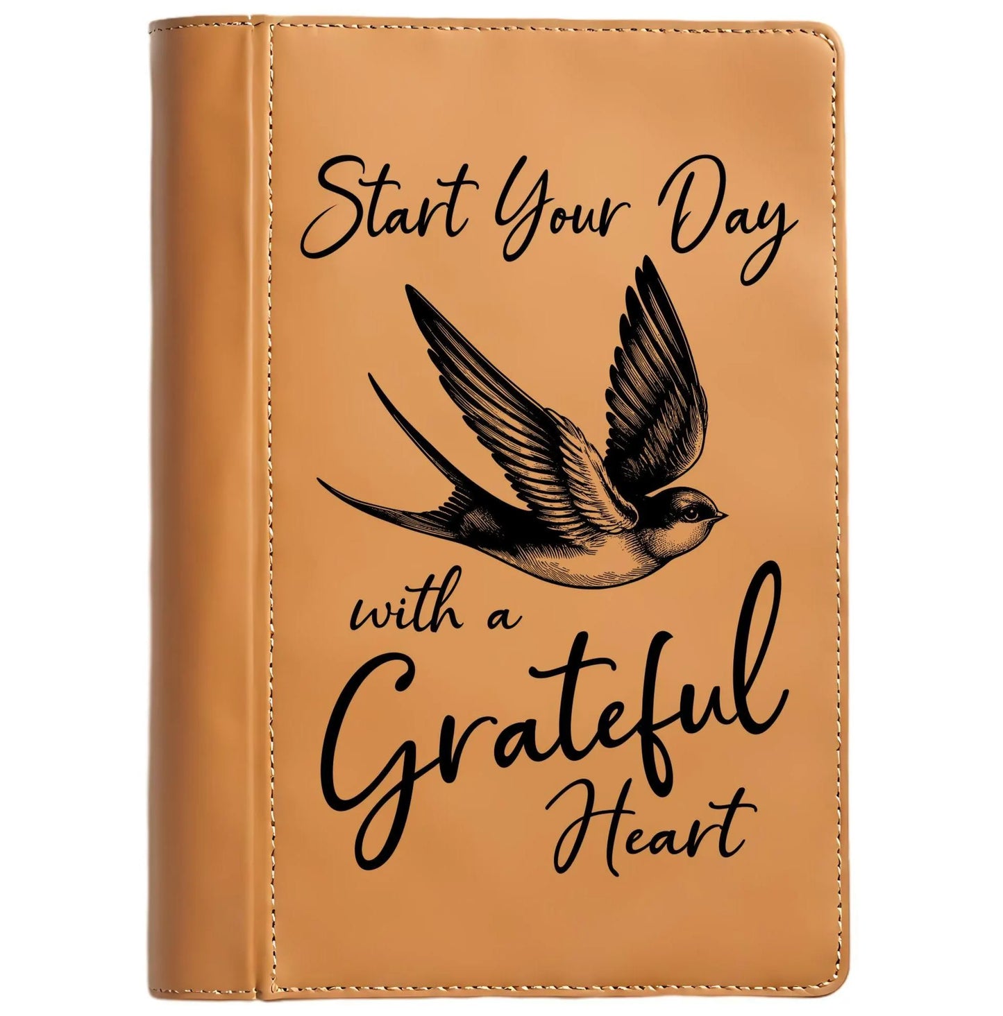 Brown leather journal cover with a bird illustration and motivational quote on a white background