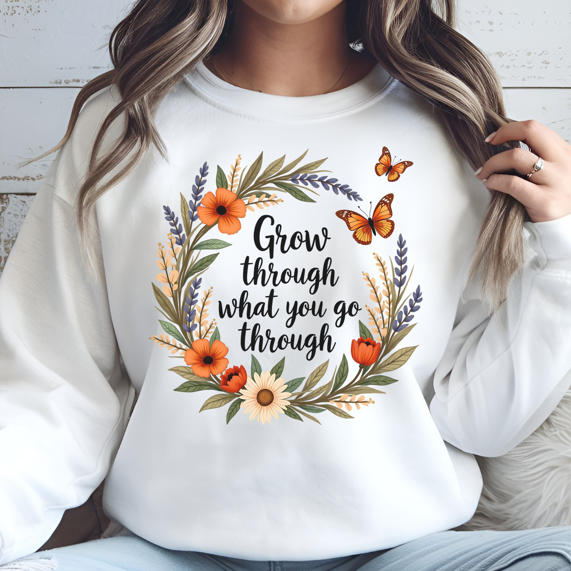 Grow Through What You Go Through PNG floral design with butterflies on a woman's white sweatshirt