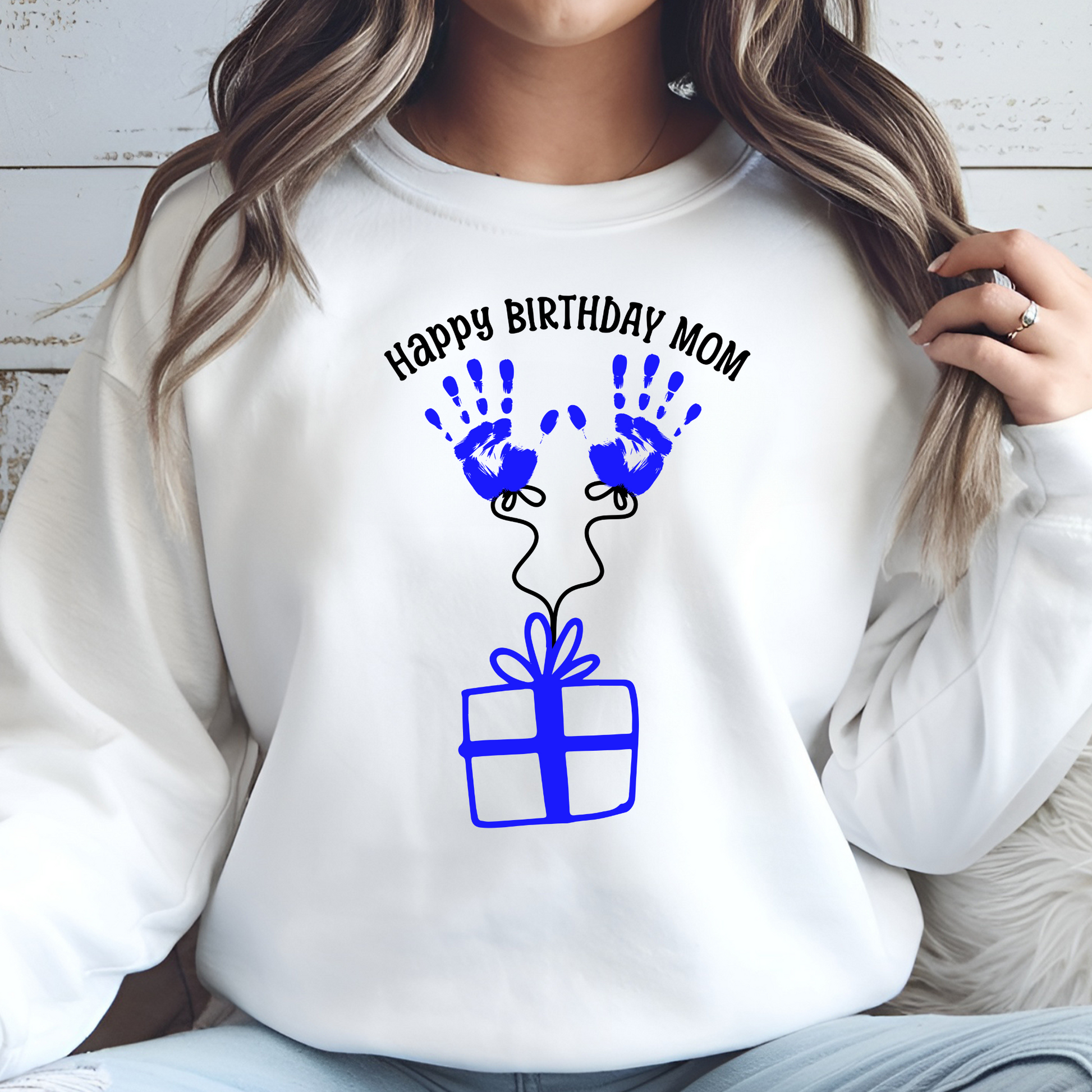 Happy Birthday Mom Blue Handprints digital design on a woman’s sweatshirt