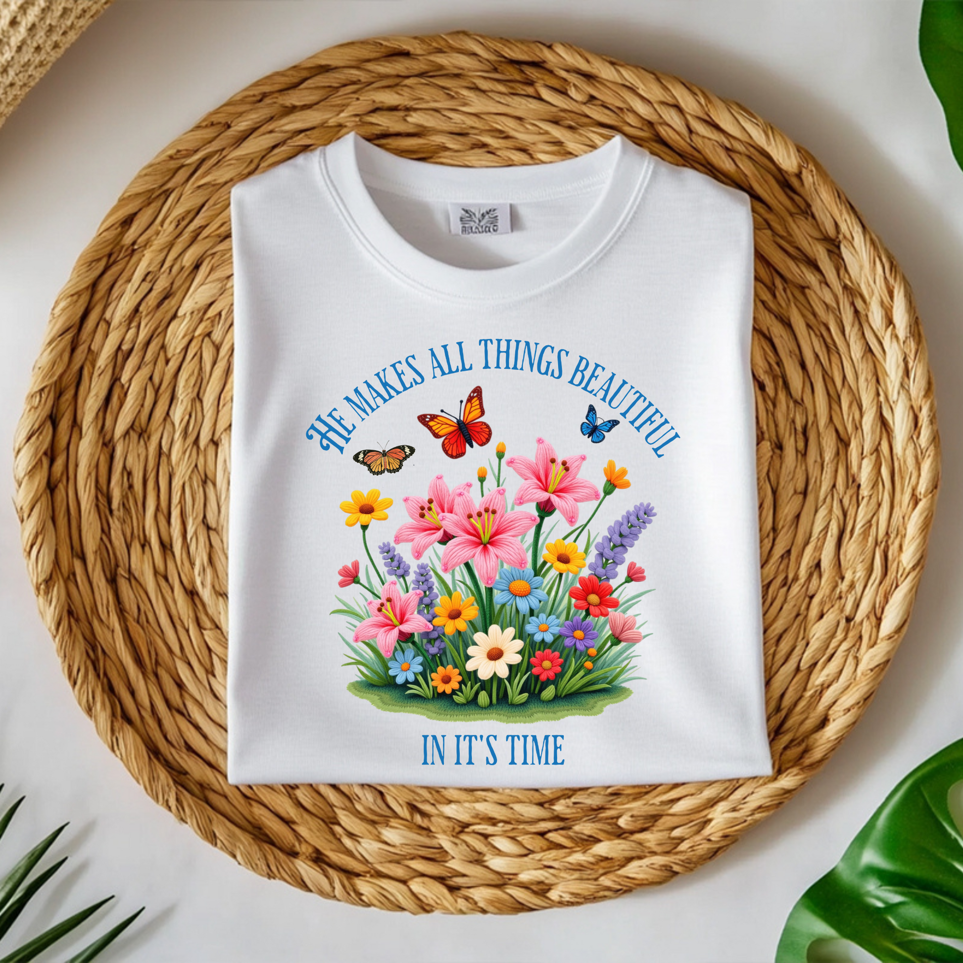 He Makes All Things Beautiful In It's Time floral design on a folded t-shirt