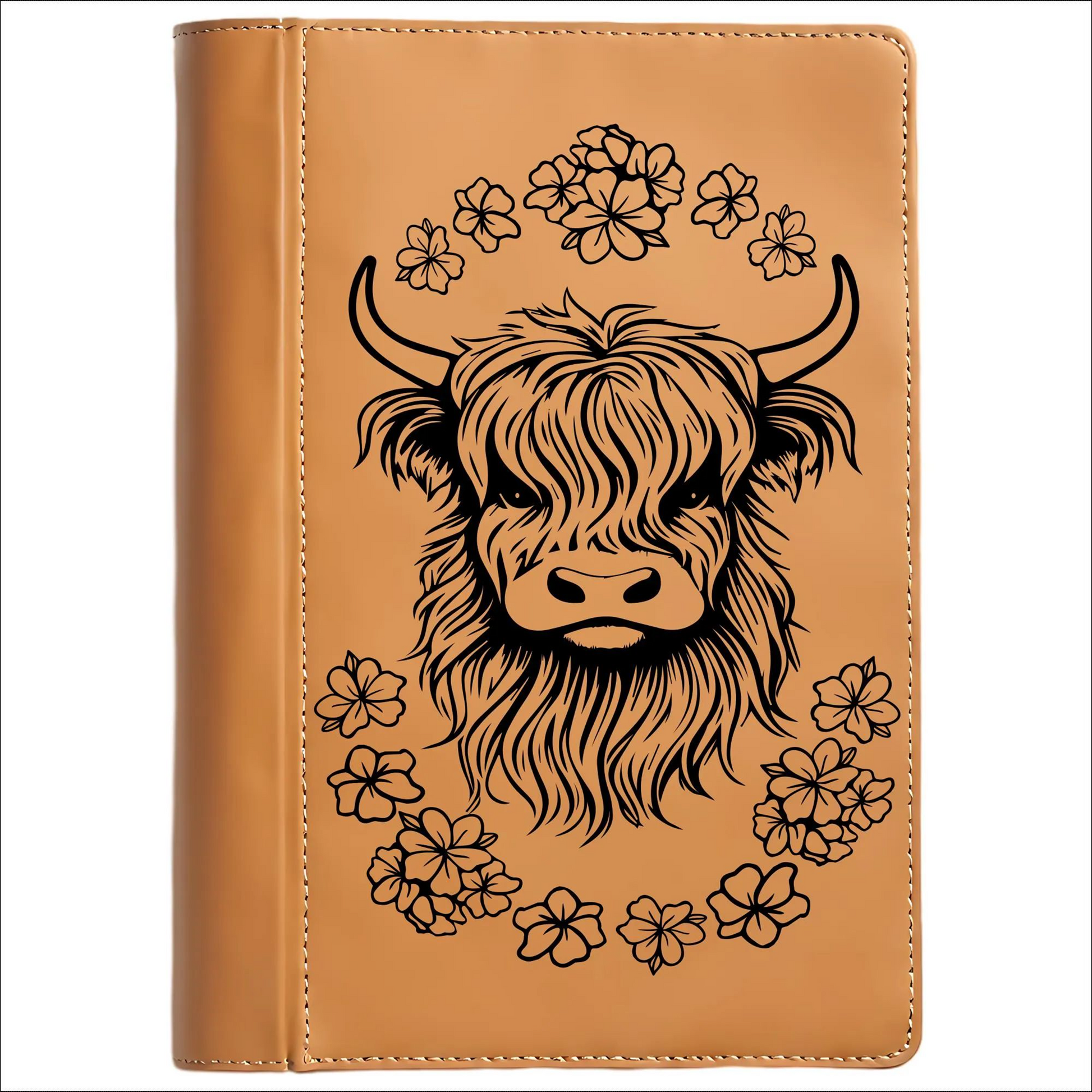 Brown leather journal with a highland cow illustration and floral elements on a white background