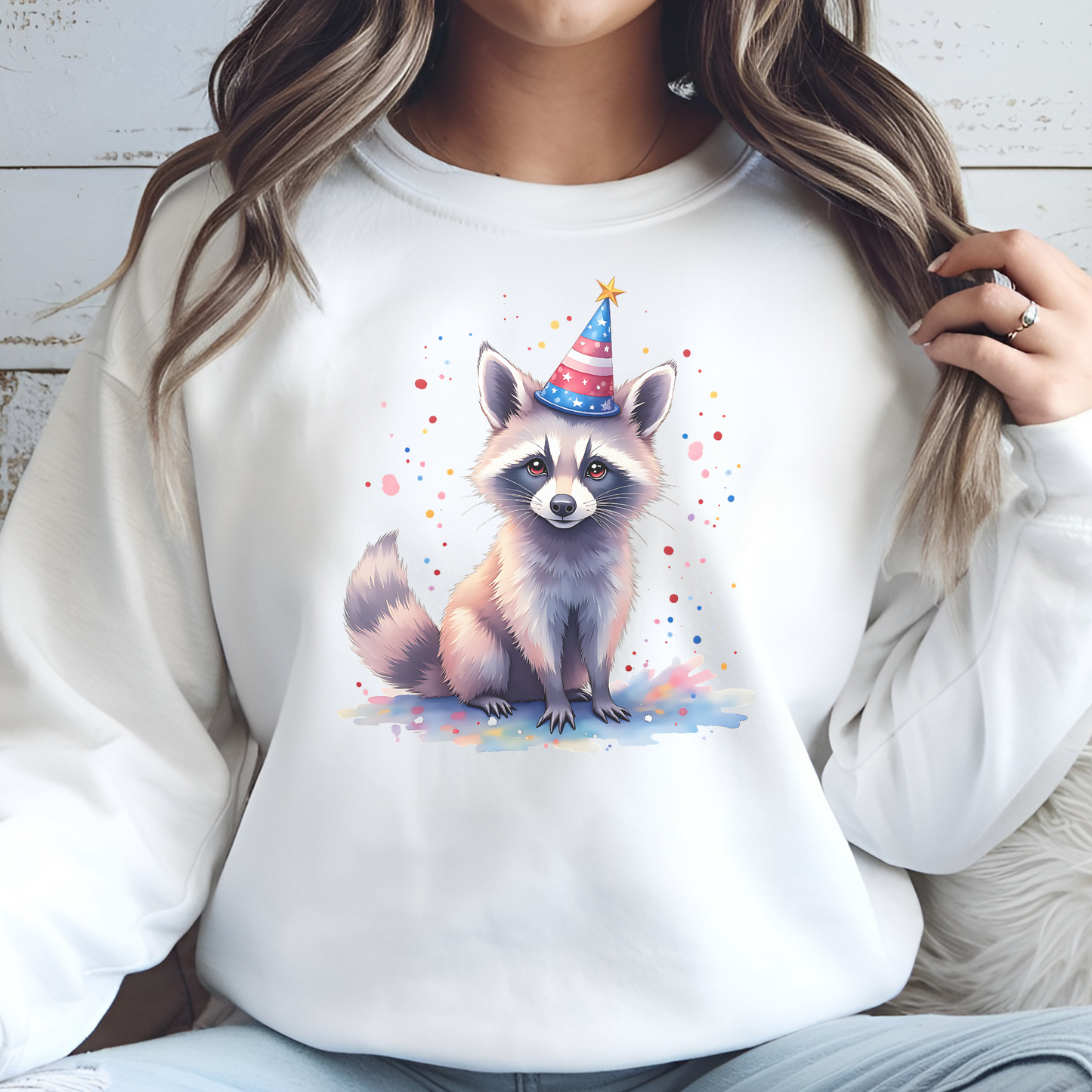 Independence Day Raccoon Party digital design on a woman's white sweatshirt