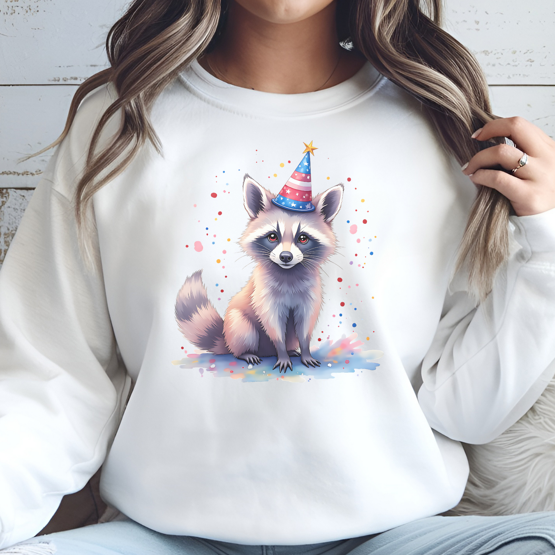 Independence Day Raccoon Party digital design on a woman's white sweatshirt