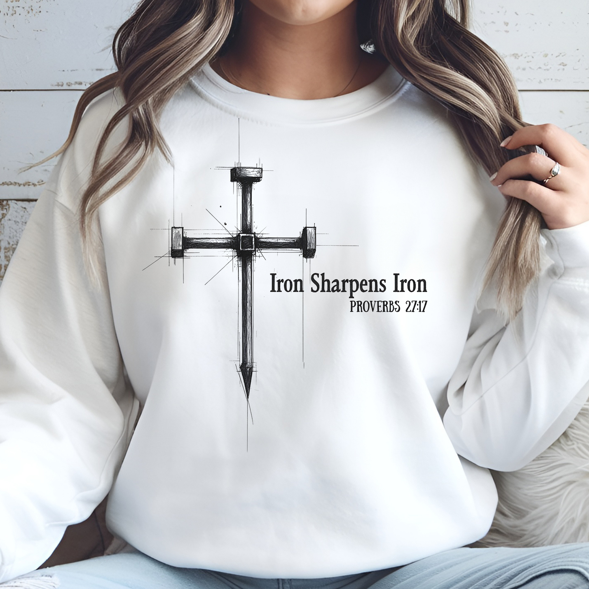 Iron Sharpens Iron digital design on a woman's white sweatwhirt