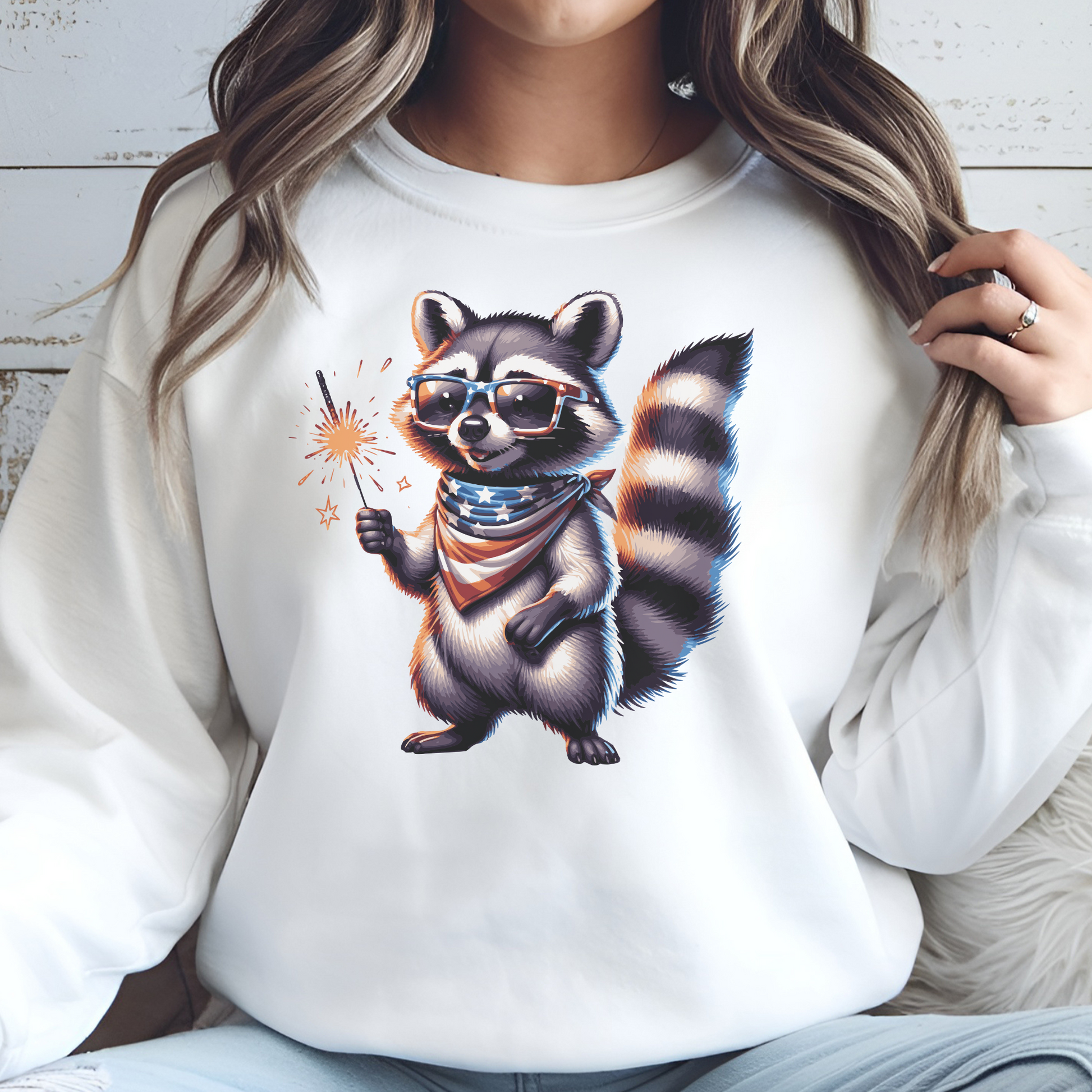 Independence Day 4th of July Raccoon Sparkler digital design on a woman's white sweatshirt