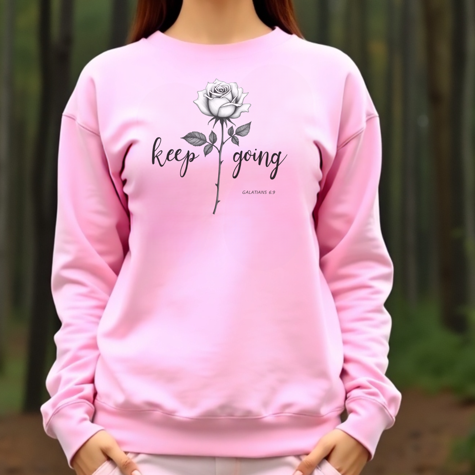 Keep Going long stem rose silhouette digital design on a pink sweatshirt