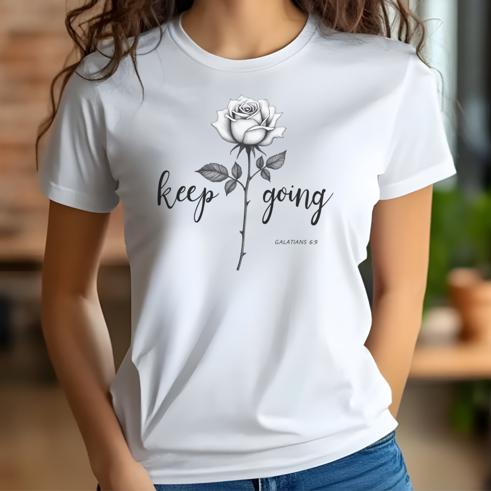 Keep Going long stem rose silhouette digital design on a woman’s white t-shirt