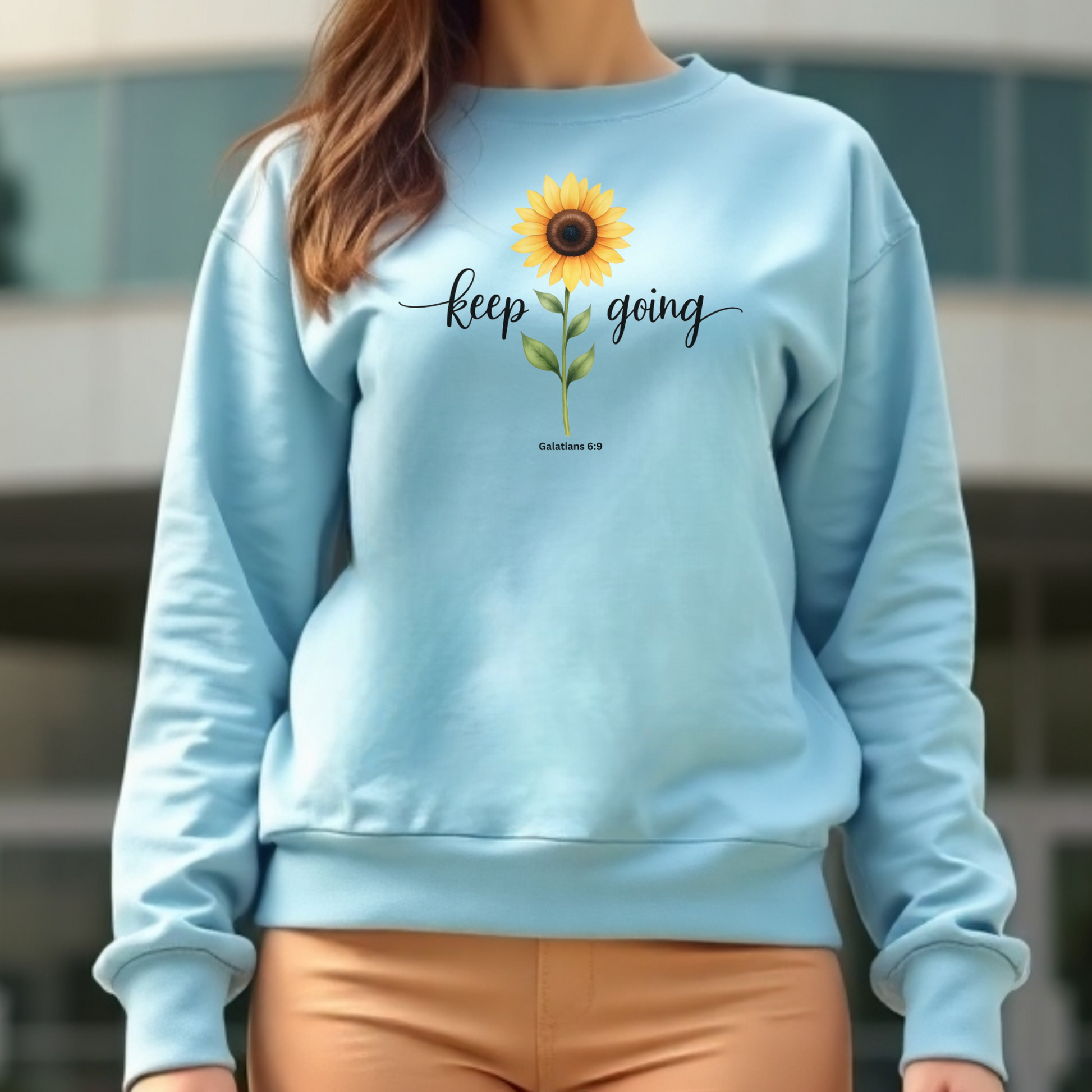 Keep Going Sunflower Galatians 6:9 digital design on a blue sweatshirt