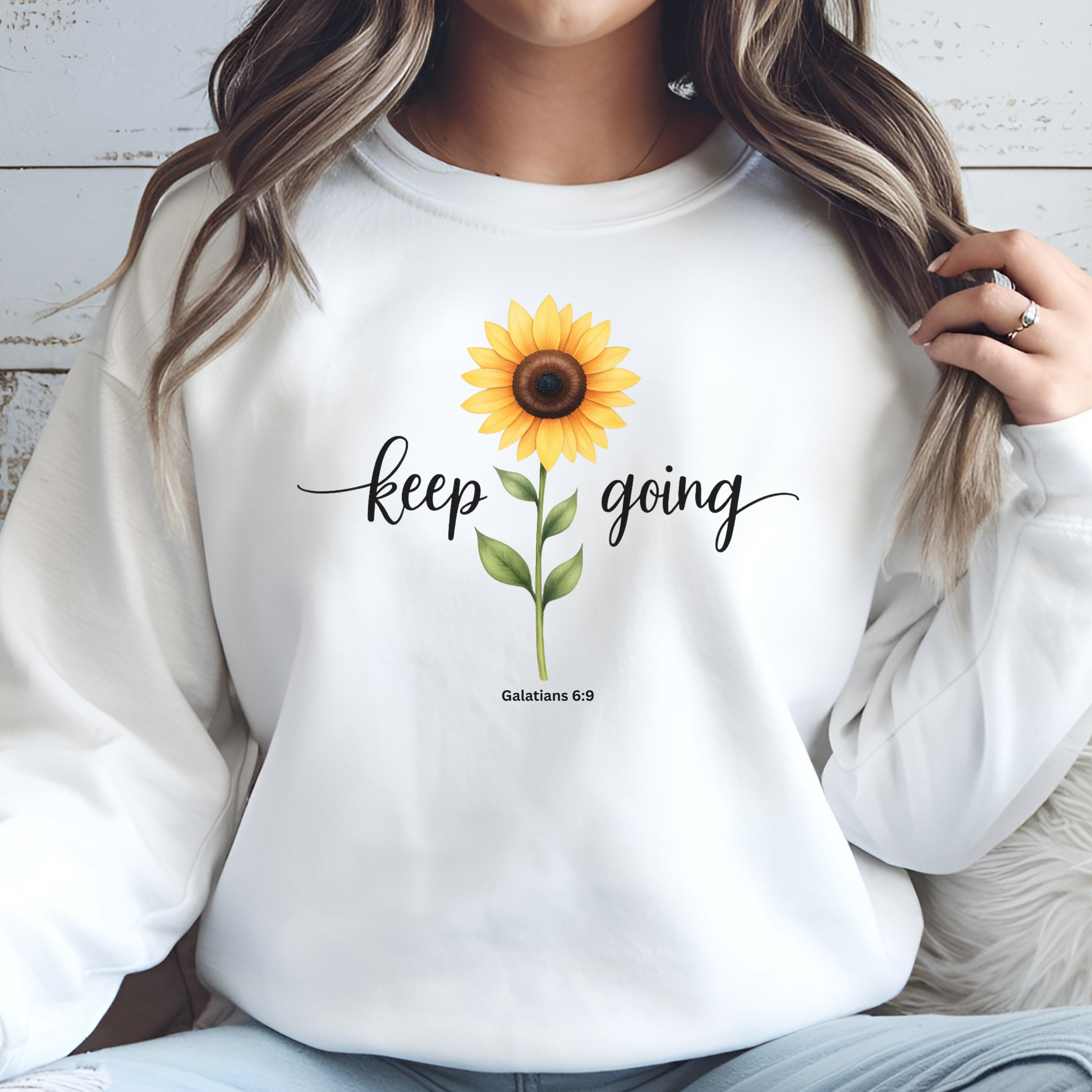 Keep Going Sunflower Galatians 6:9 digital design on a white sweatshirt