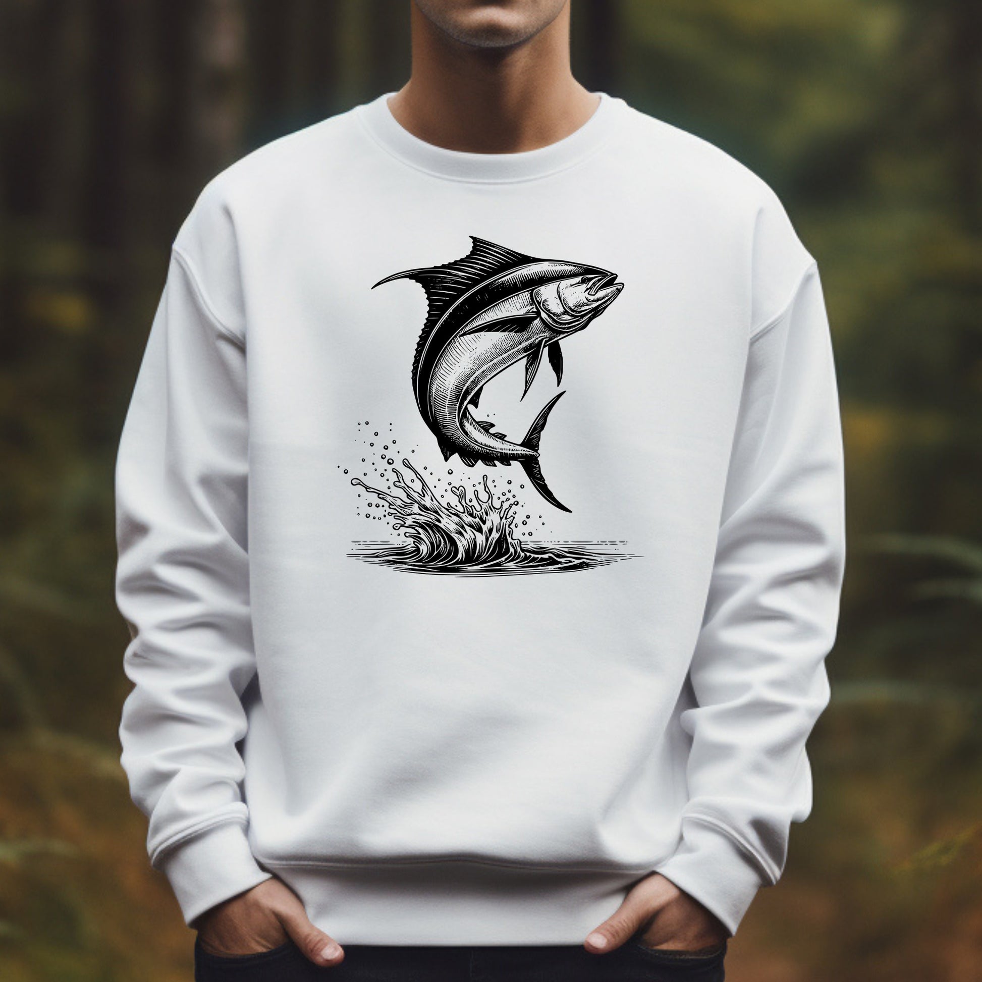White sweatshirt with a mahi-mahi graphic worn by a man against a blurred natural background