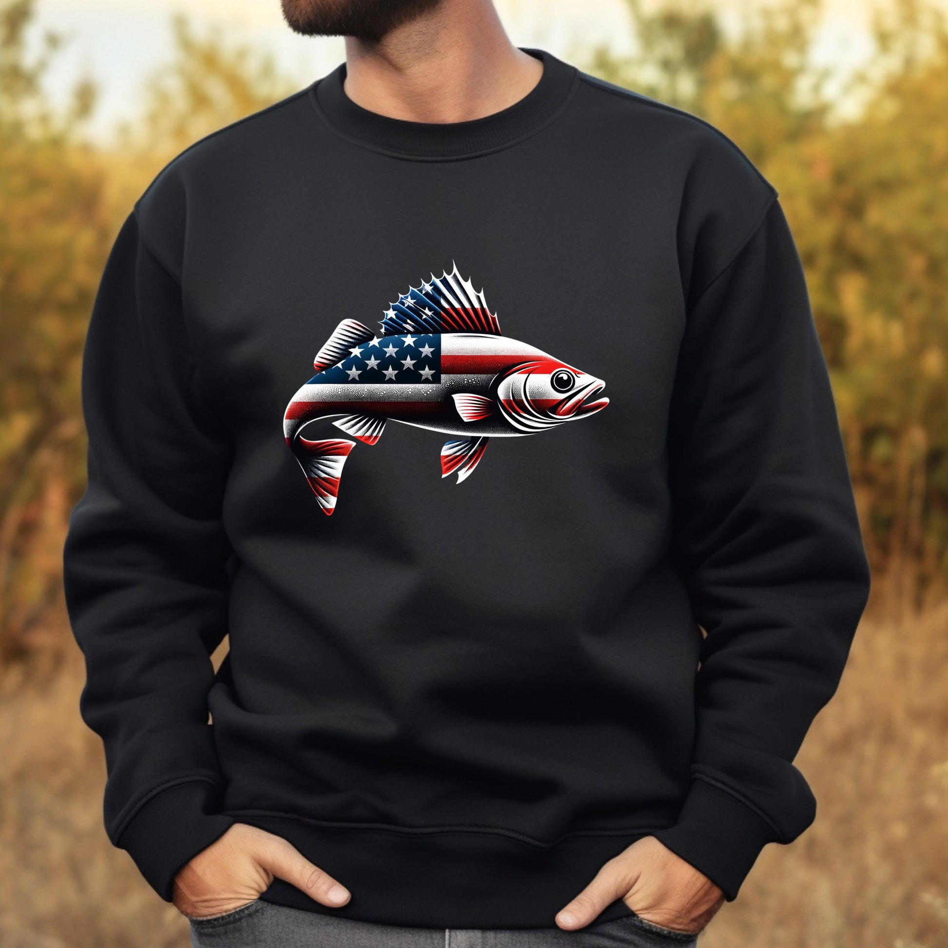Black sweatshirt with a fish design featuring the American flag, worn by a man outdoors.