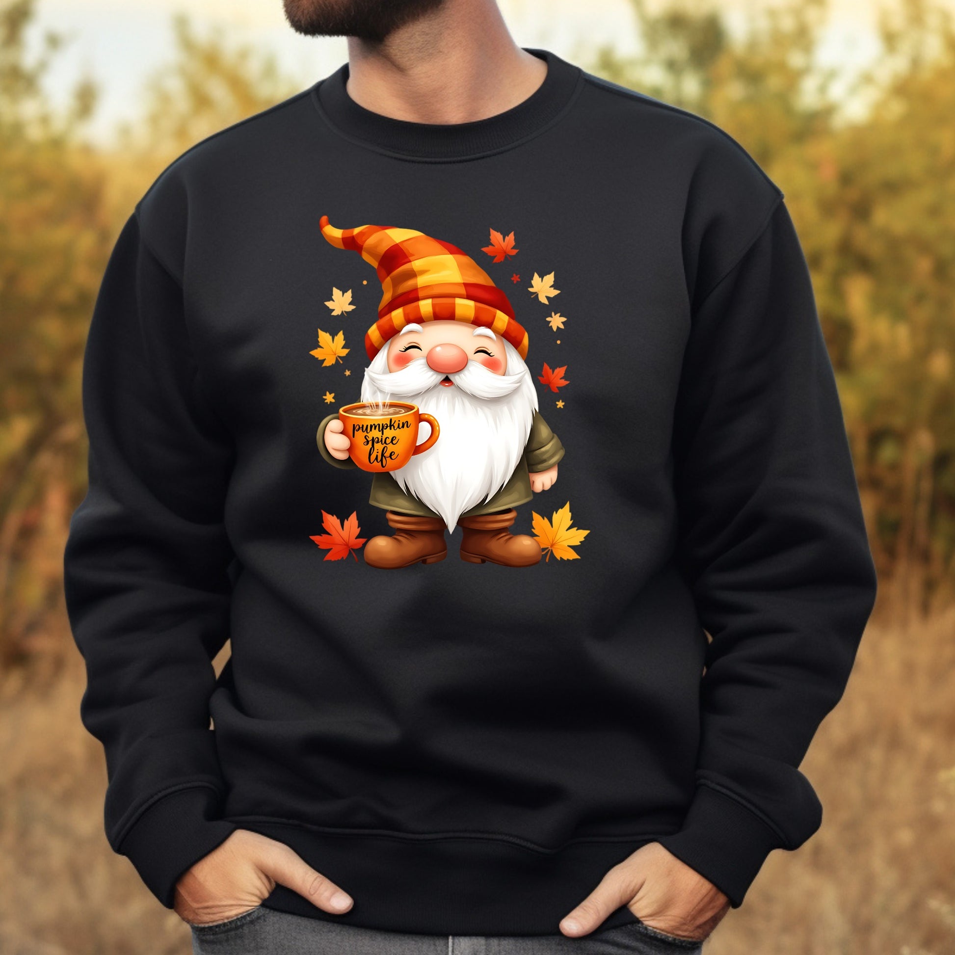 Black sweatshirt with a cartoon gnome holding a mug and autumn leaves on a blurred natural background