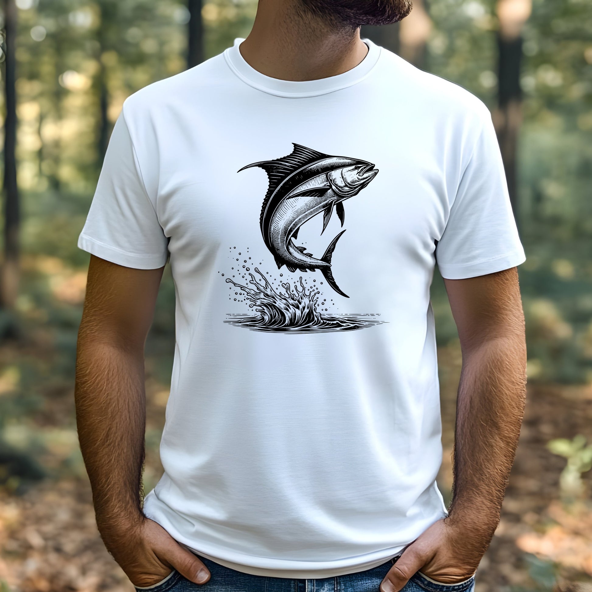 Man wearing a white t-shirt with a black mahi-mahi fish graphic in a forest setting