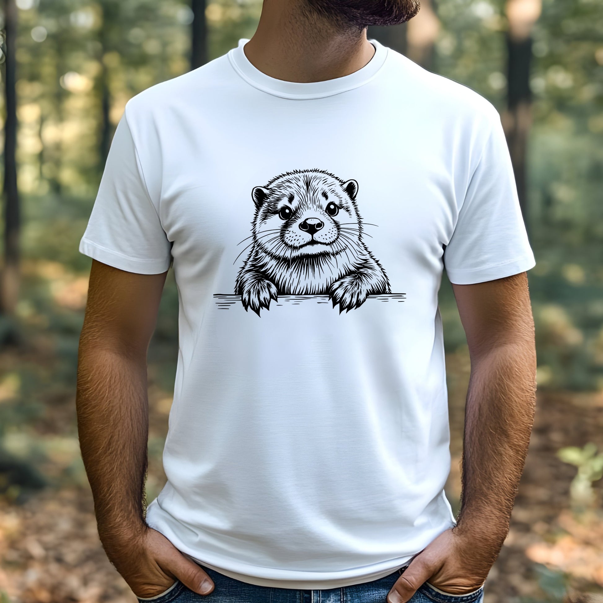 A man wearing a white t-shirt with an otter graphic in a forest setting