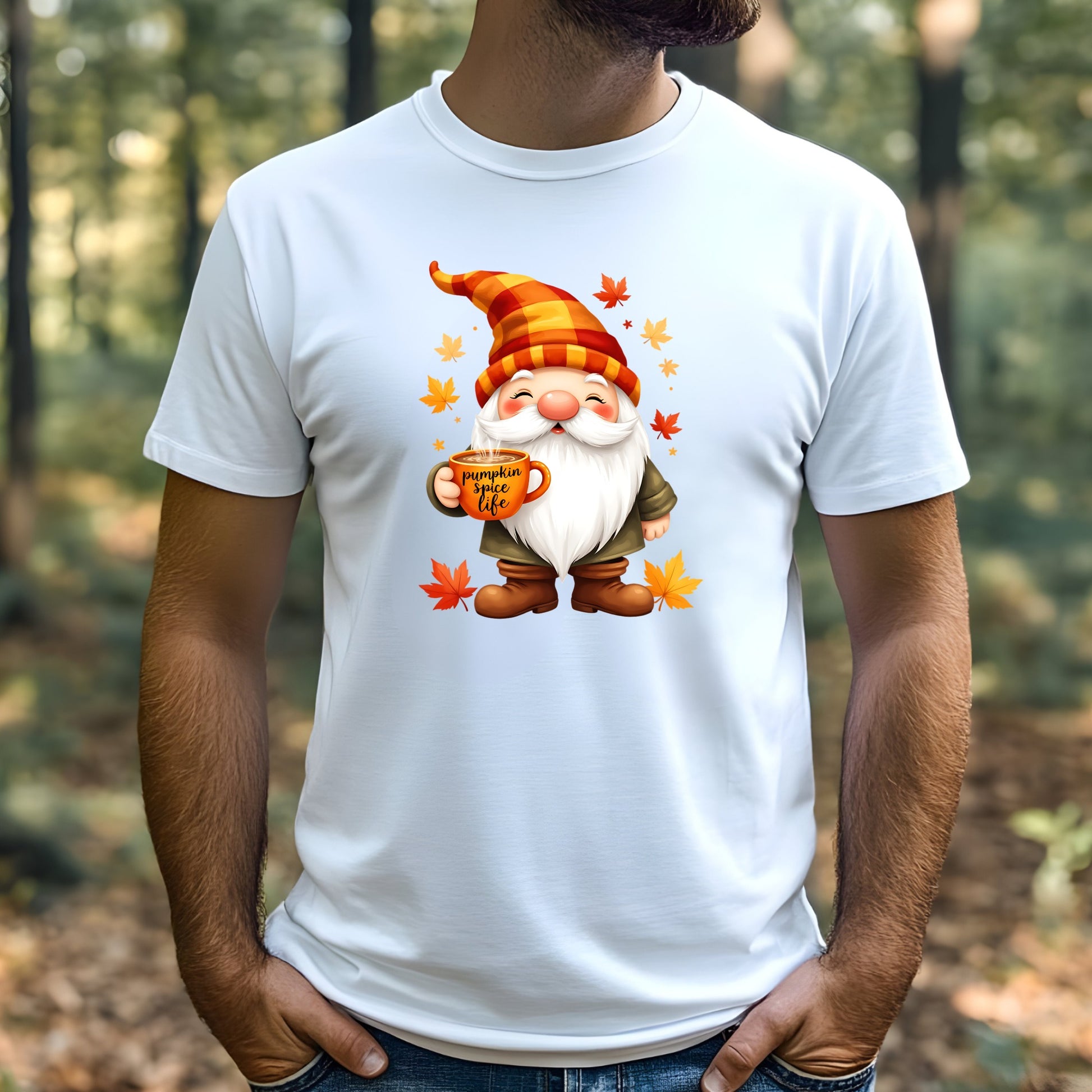 White t-shirt with a cartoon gnome holding a mug and autumn leaves, worn by a man outdoors.