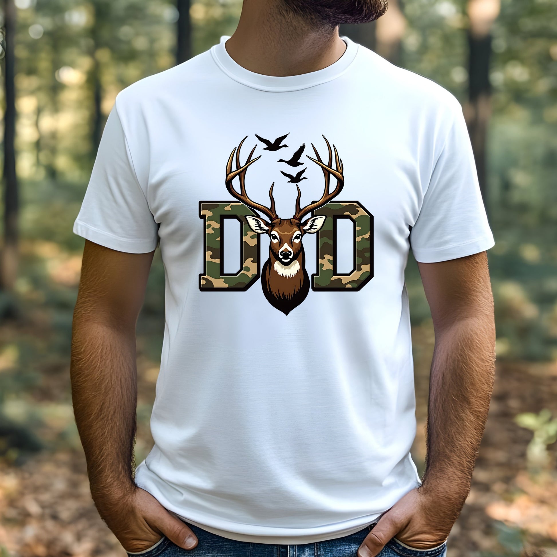 Man wearing a white t-shirt with a deer and 'Dad' graphic in the woods