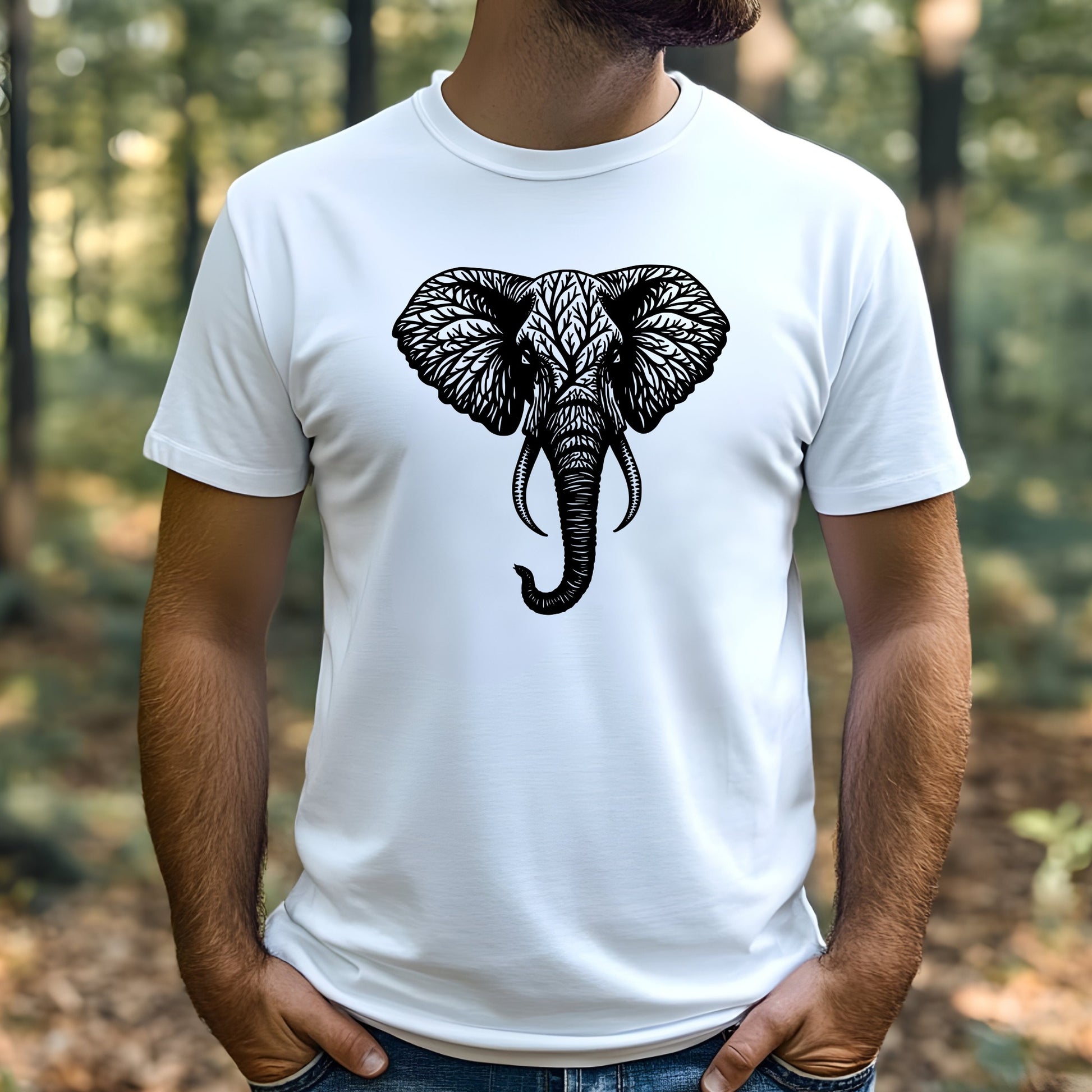 A man wearing a white t-shirt with a black elephant tree design outdoors.