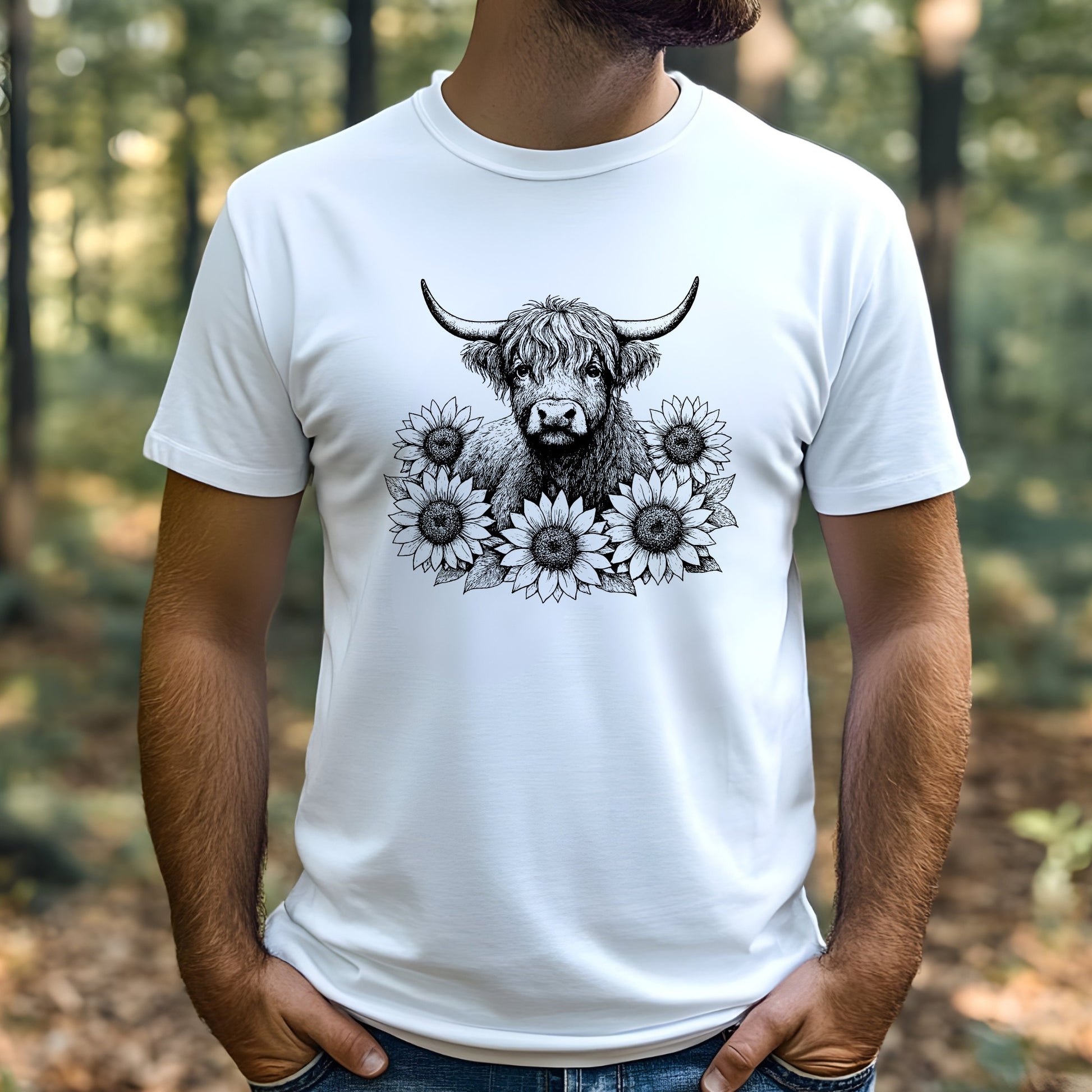 Person wearing a white t-shirt with a highland cow and floral design outdoors.