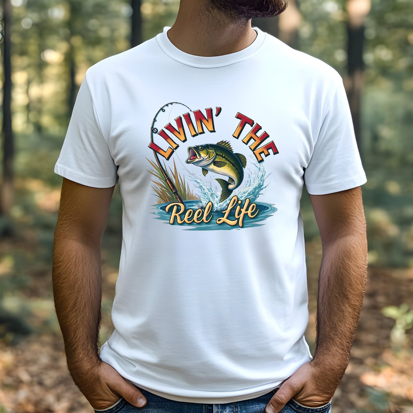 Man wearing a white t-shirt with a fishing graphic and text 'Livin' The Reel Life' in a forest setting.