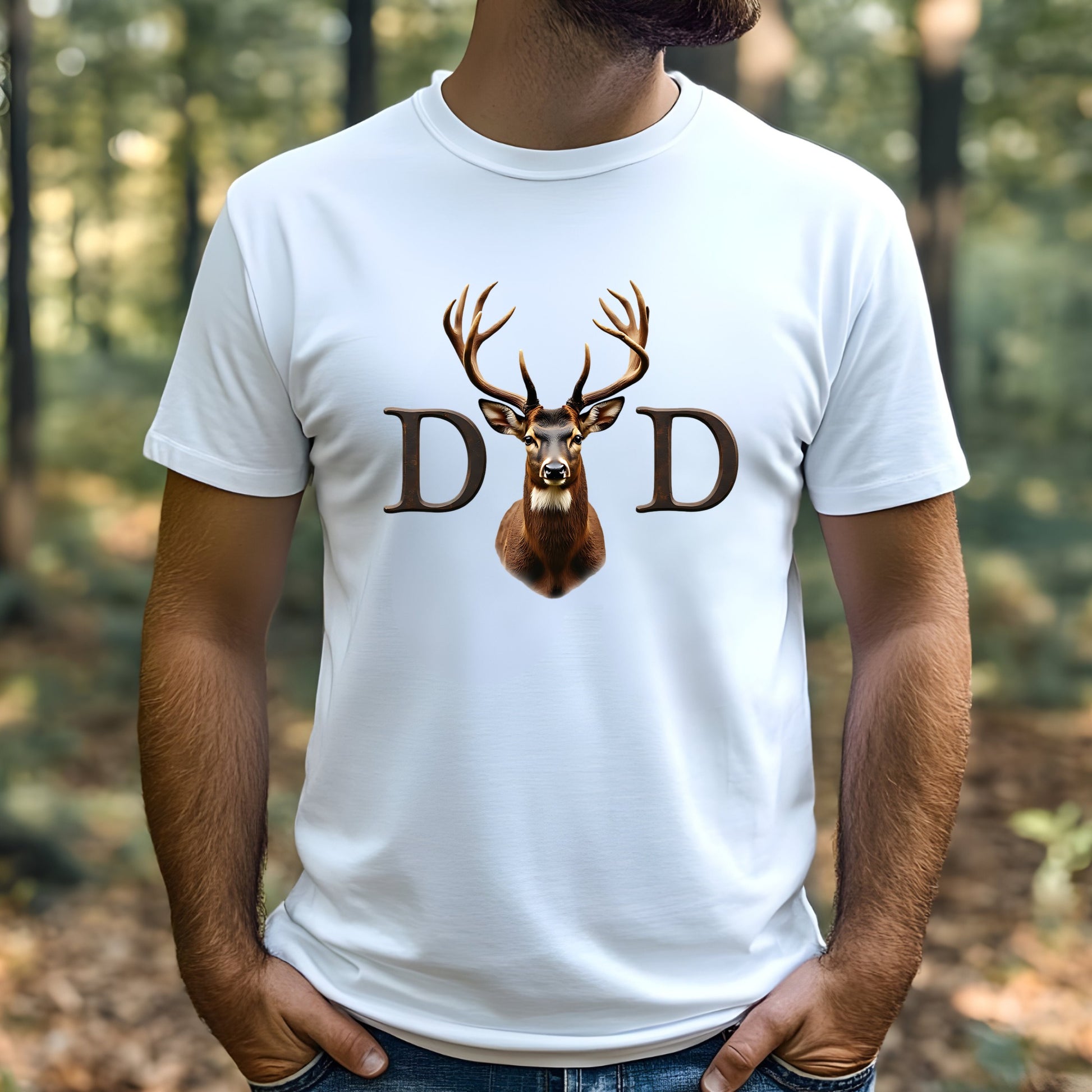 Man wearing a white t-shirt with a deer graphic and 'DAD' text in a forest setting