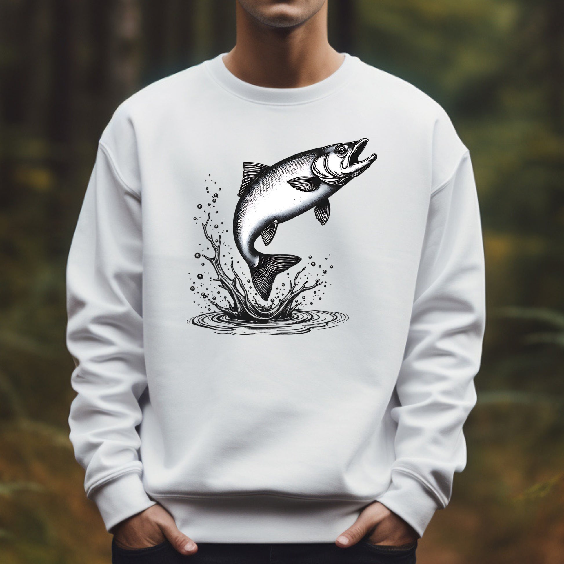 White sweatshirt with a salmon leaping graphic worn by a man in a forest setting