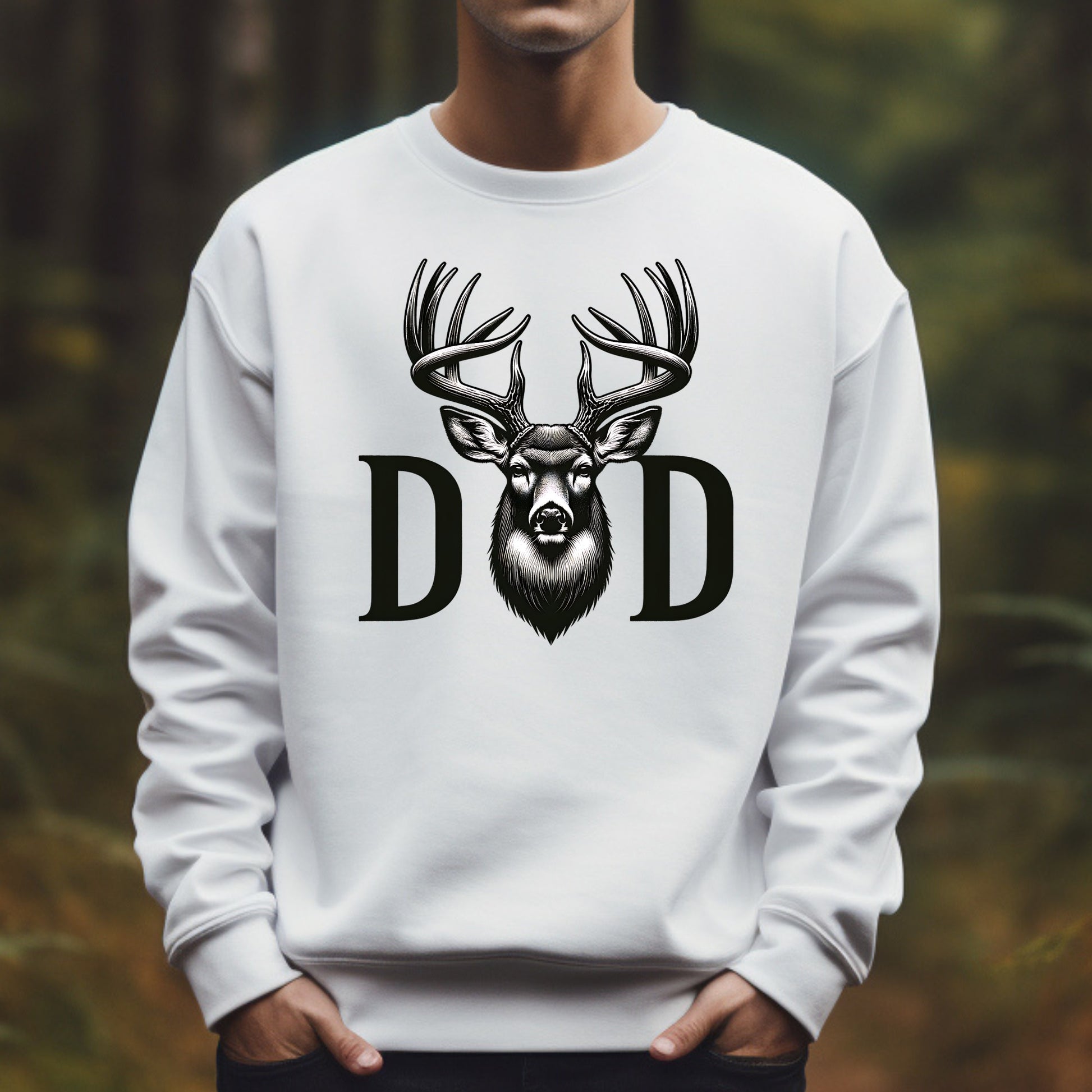 White sweatshirt with a deer design and 'DAD' text against a blurred natural background