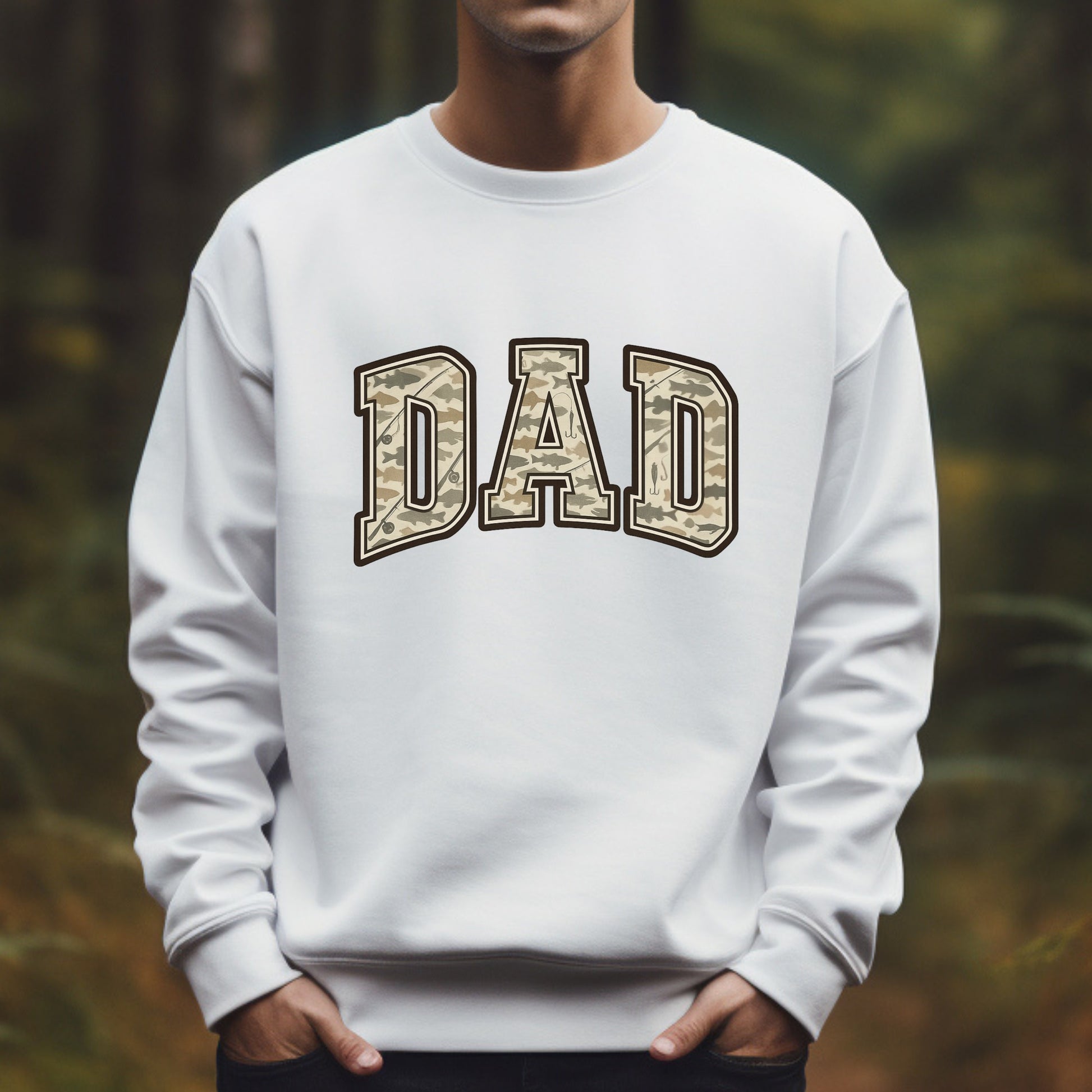 White sweatshirt with 'DAD' printed in camouflage letters against a blurred natural background