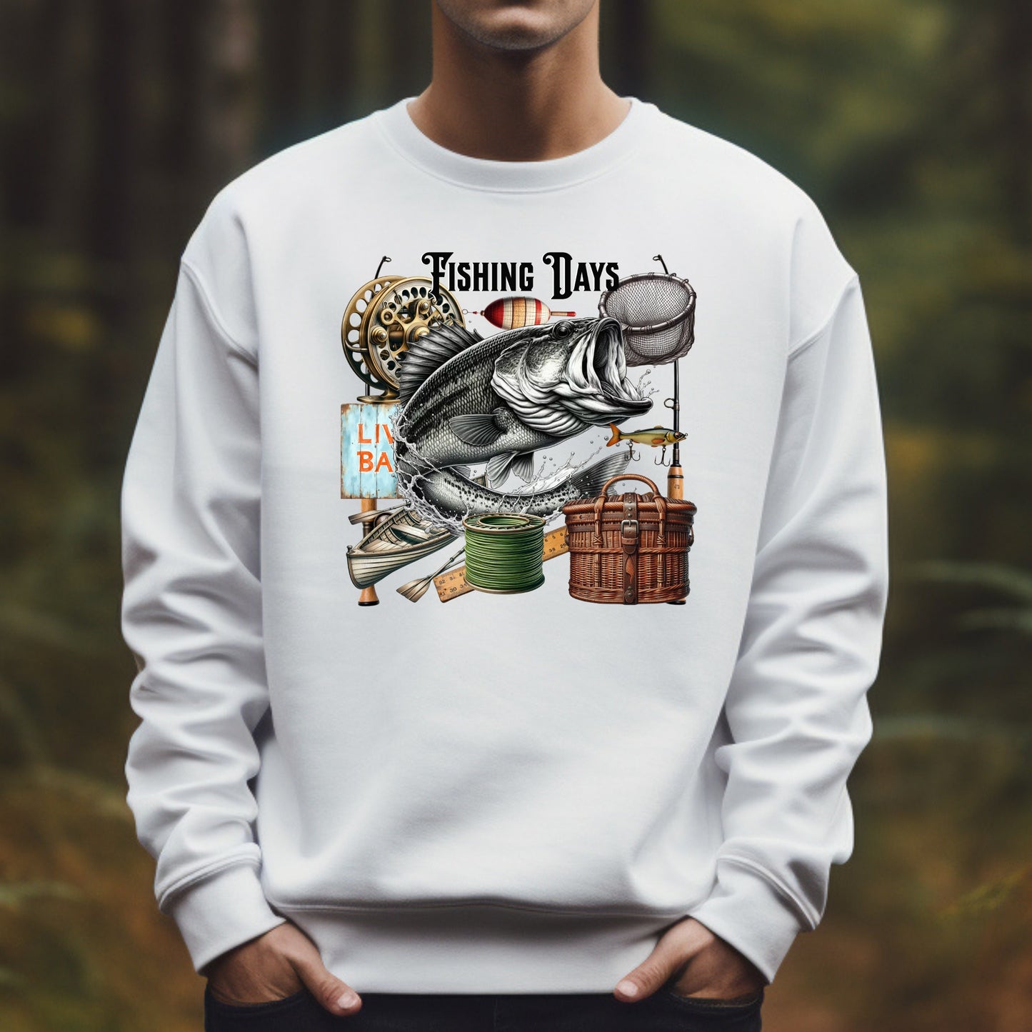 White sweatshirt with fishing-themed design featuring a fish and related equipment against a blurred natural background.