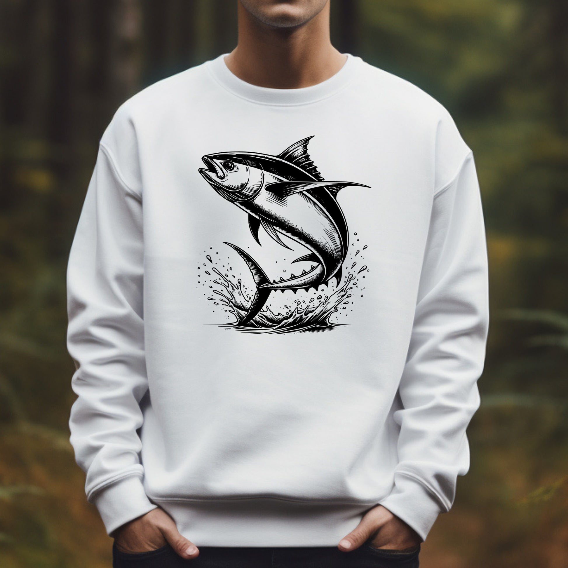 White sweatshirt with a tuna fish graphic worn by a man in a forest setting