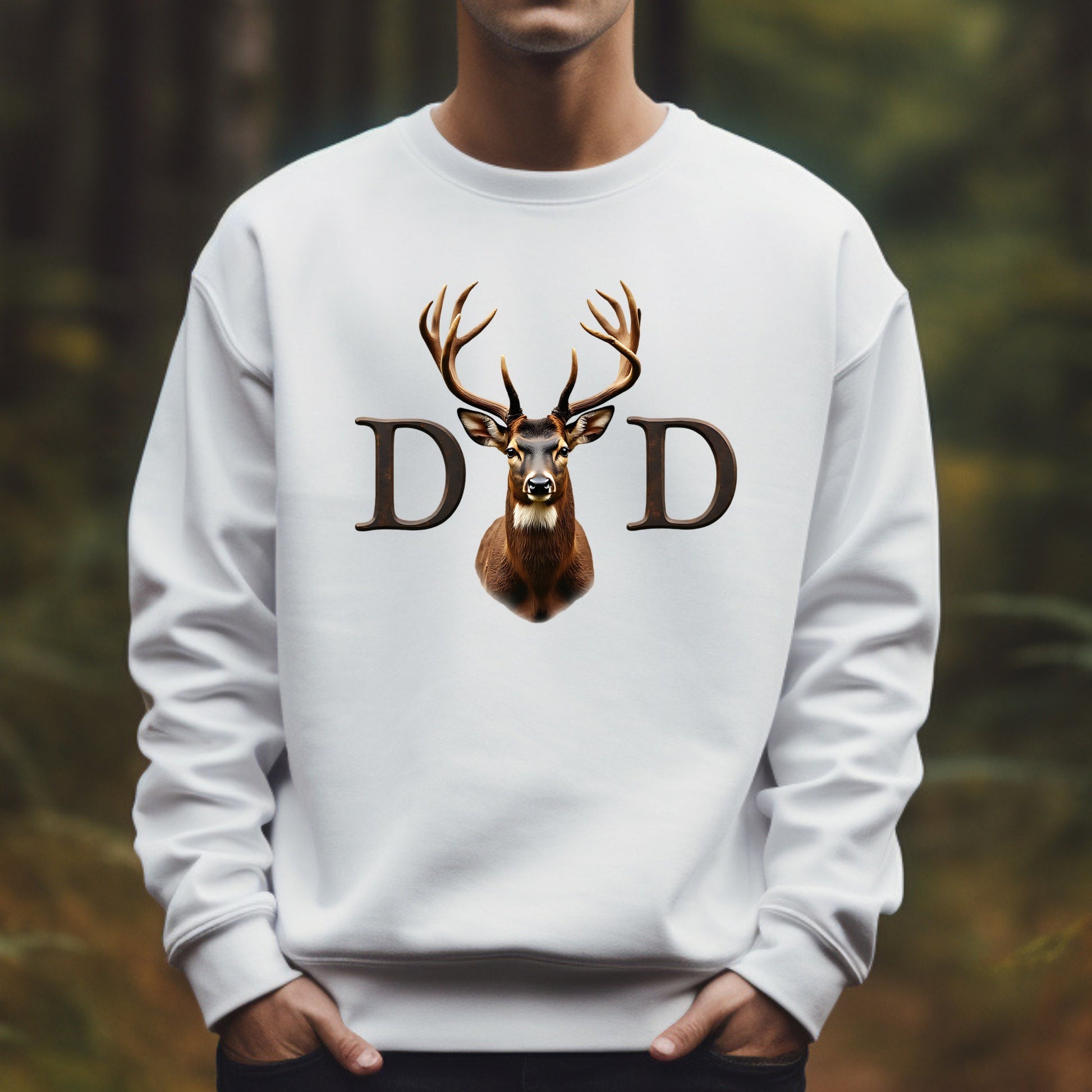 White sweatshirt with a deer design and 'DD' letters against a blurred forest background