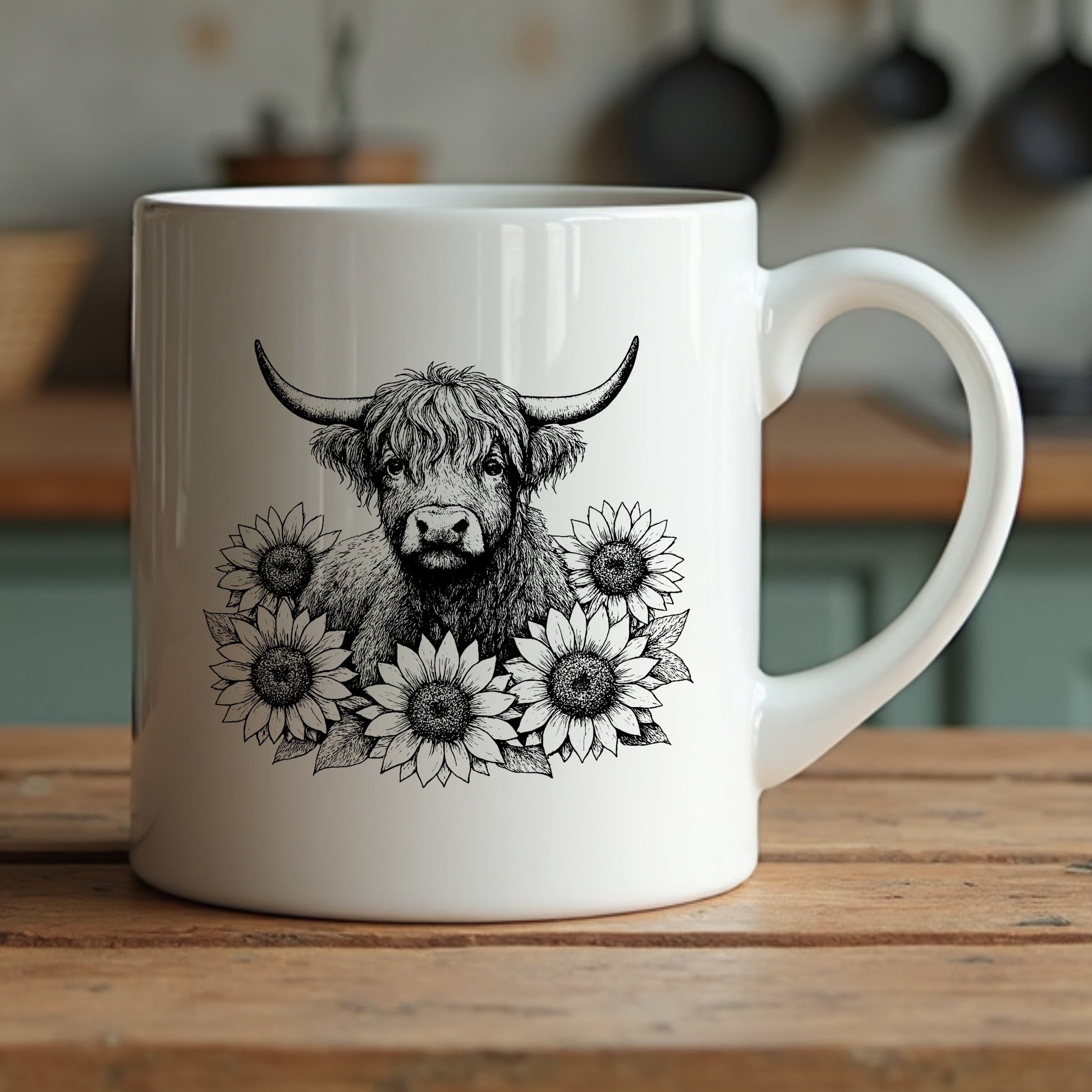 White mug with a highland cow and sunflower design on a wooden surface.