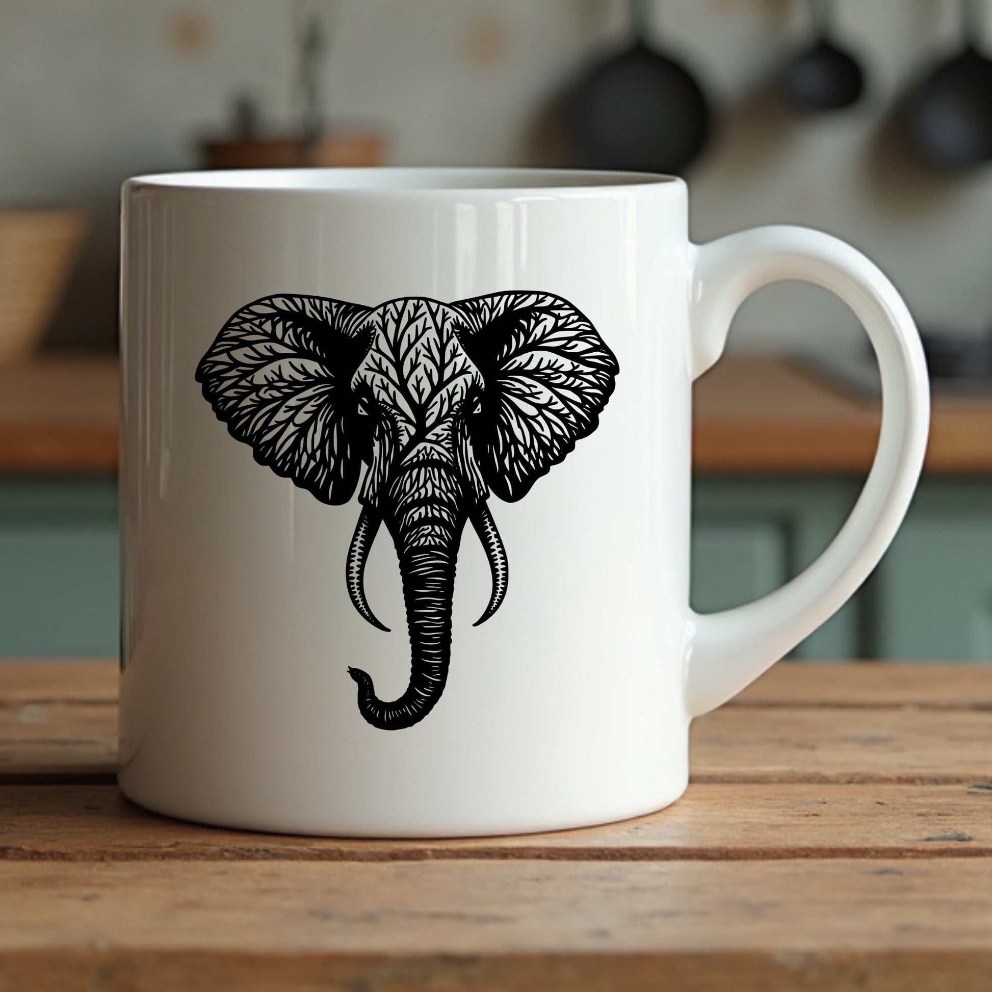 White mug with black elephant design sitting on a wooden surface
